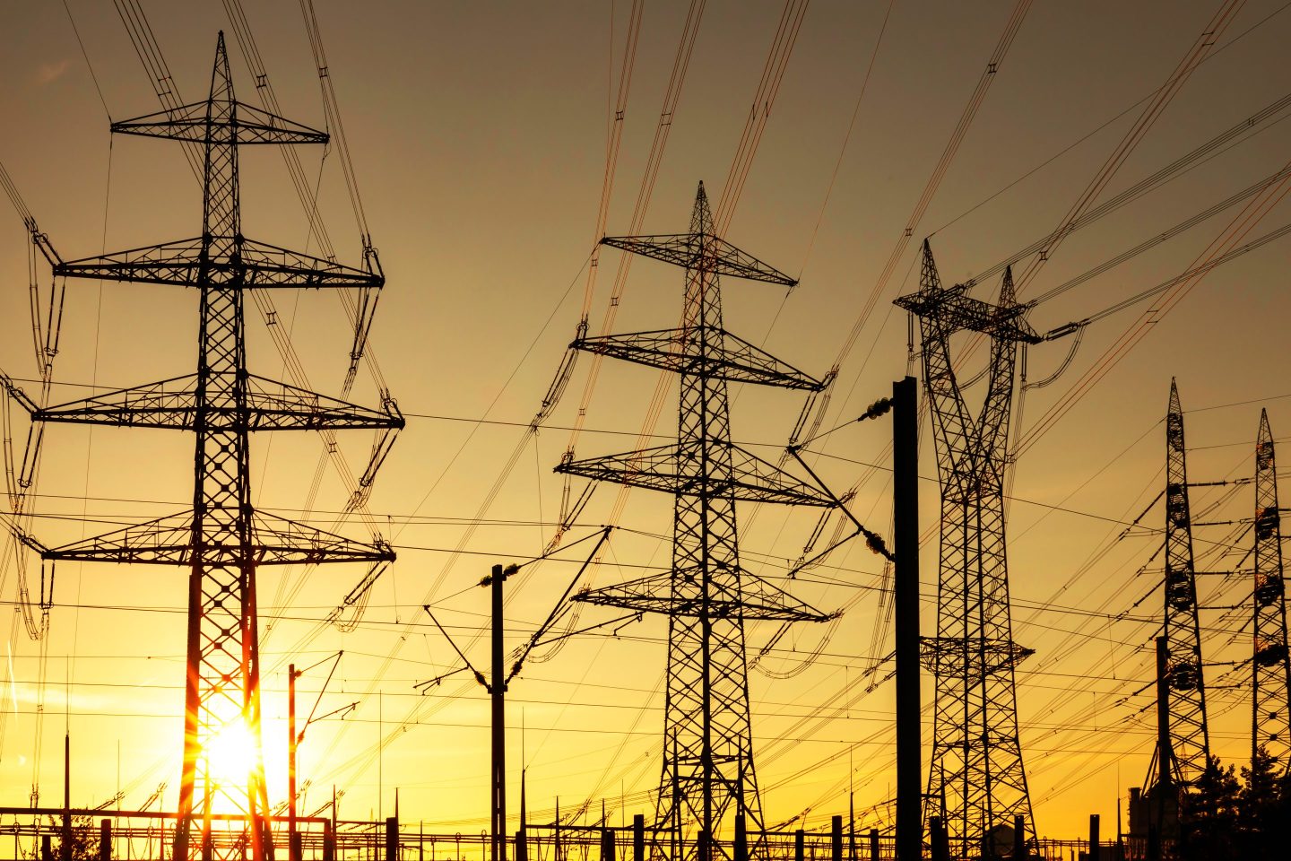 Large electricity pylons at sunset