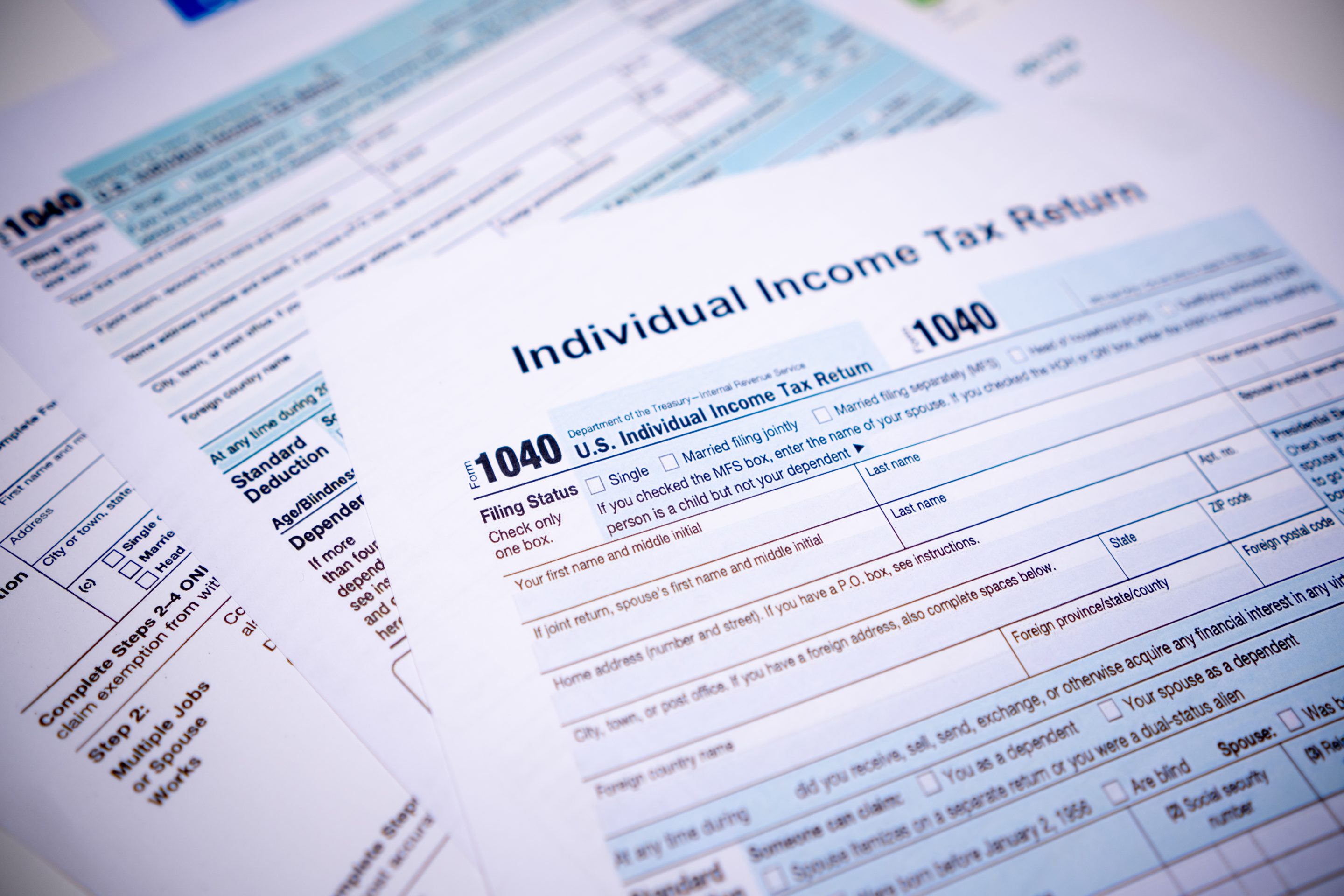 Photo of paper tax forms spread out on a table
