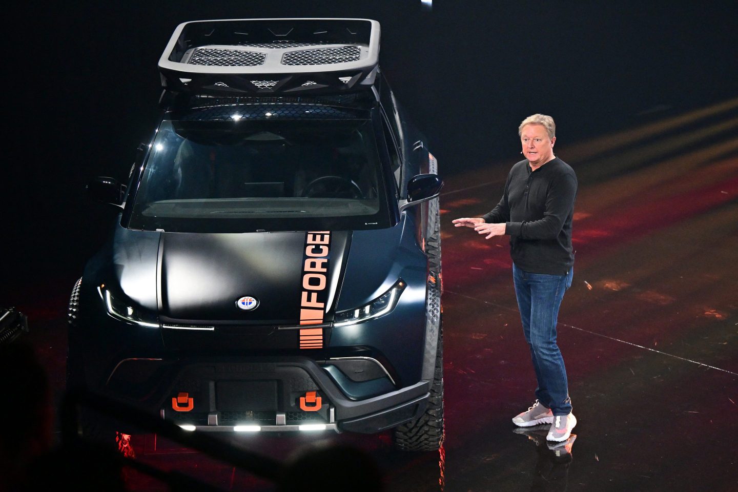 fisker ceo henrik fisker standing beside a black car