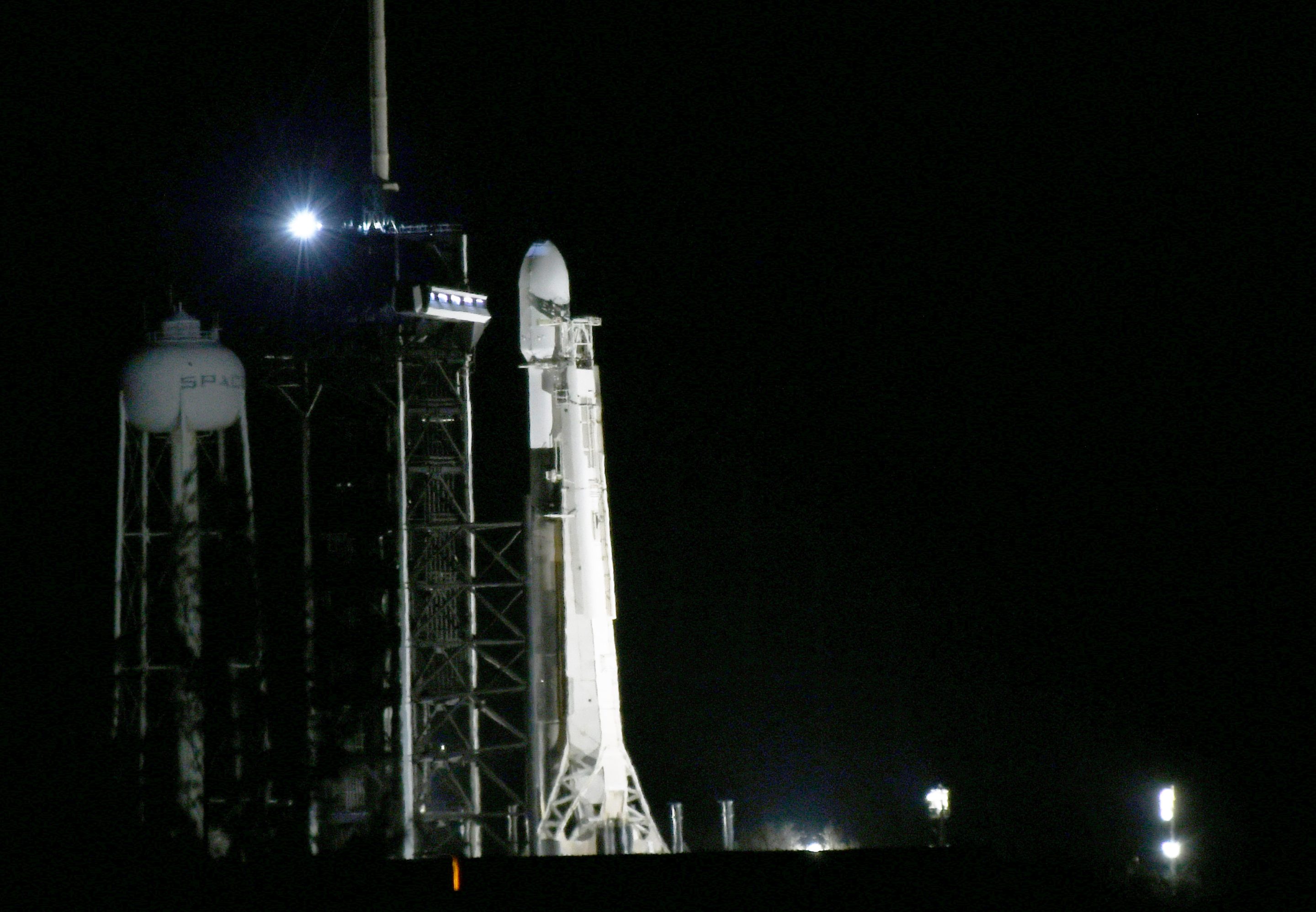 A SpaceX Falcon 9 rocket carrying the Nova-C lander for the IM-1 mission stands at pad 39A at the Kennedy Space Center after the scheduled launch of the rocket on Feb. 14, 2024 was postponed due to a technical issue in Cape Canaveral, Fla.