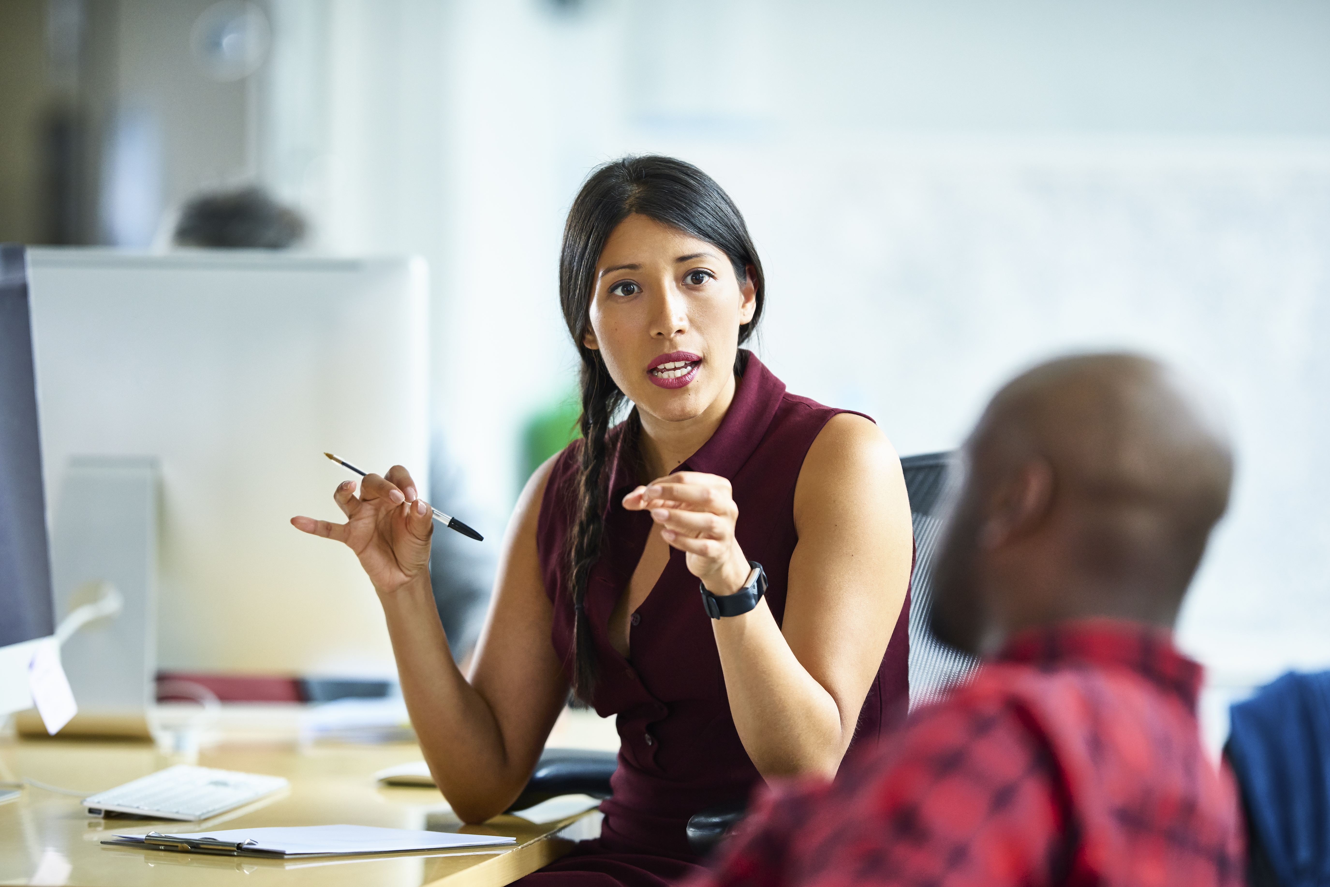 Woman leader talks to employee.