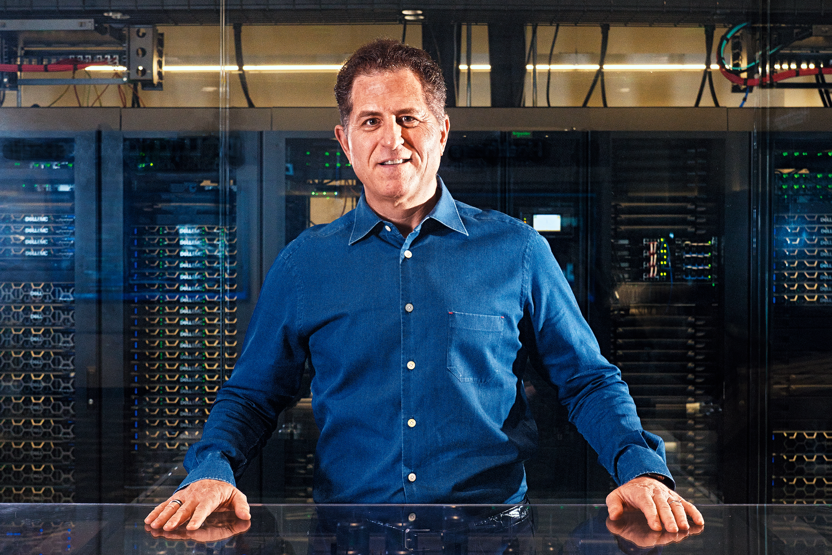 Michael Dell poses behind a model of a candy-manufacturing facility—one
theoretically powered by Dell Technologies cameras, sensors, and servers.