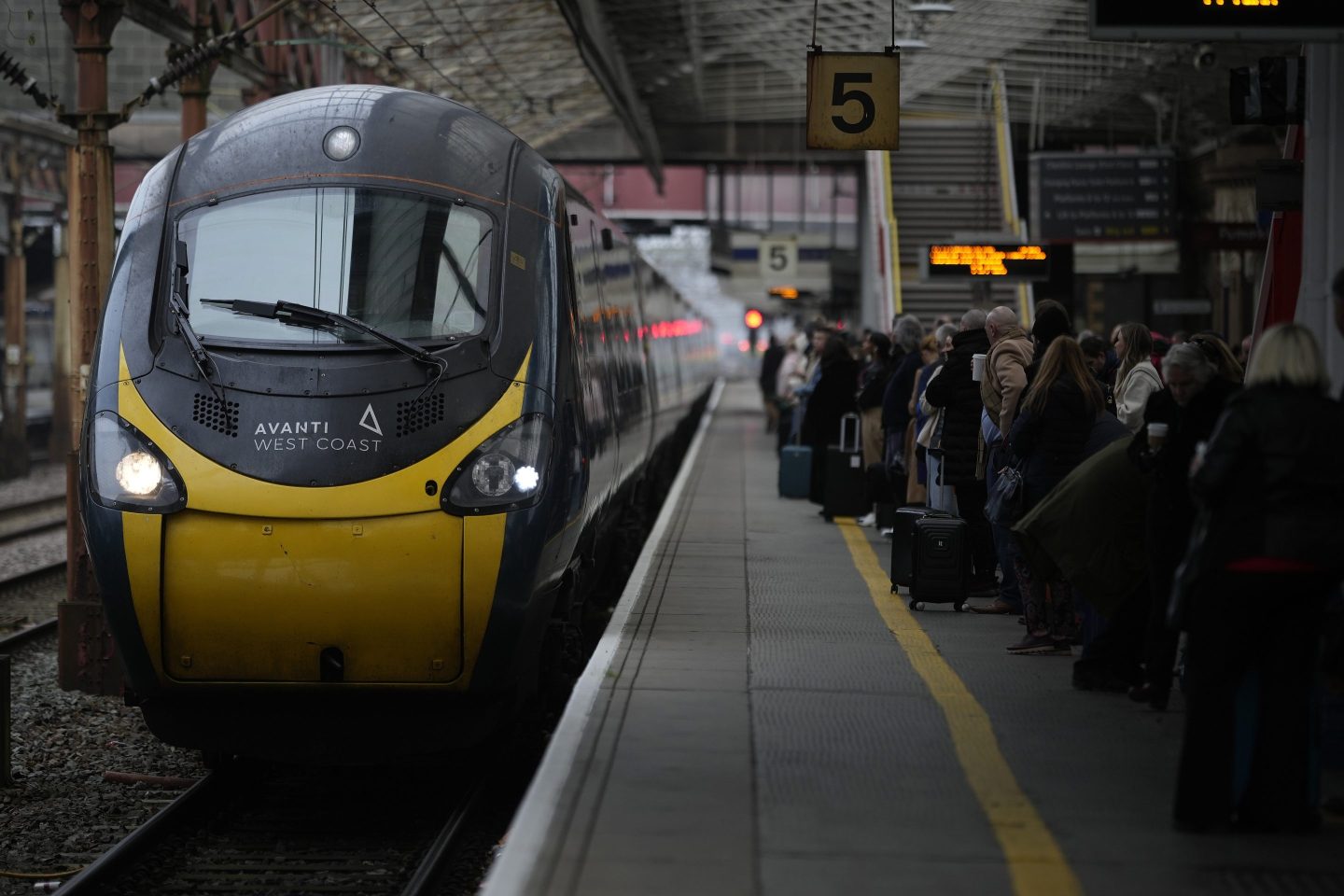 Passengers wait to board an Avanti West Coast mainline train at Crewe Station on December 01, 2022