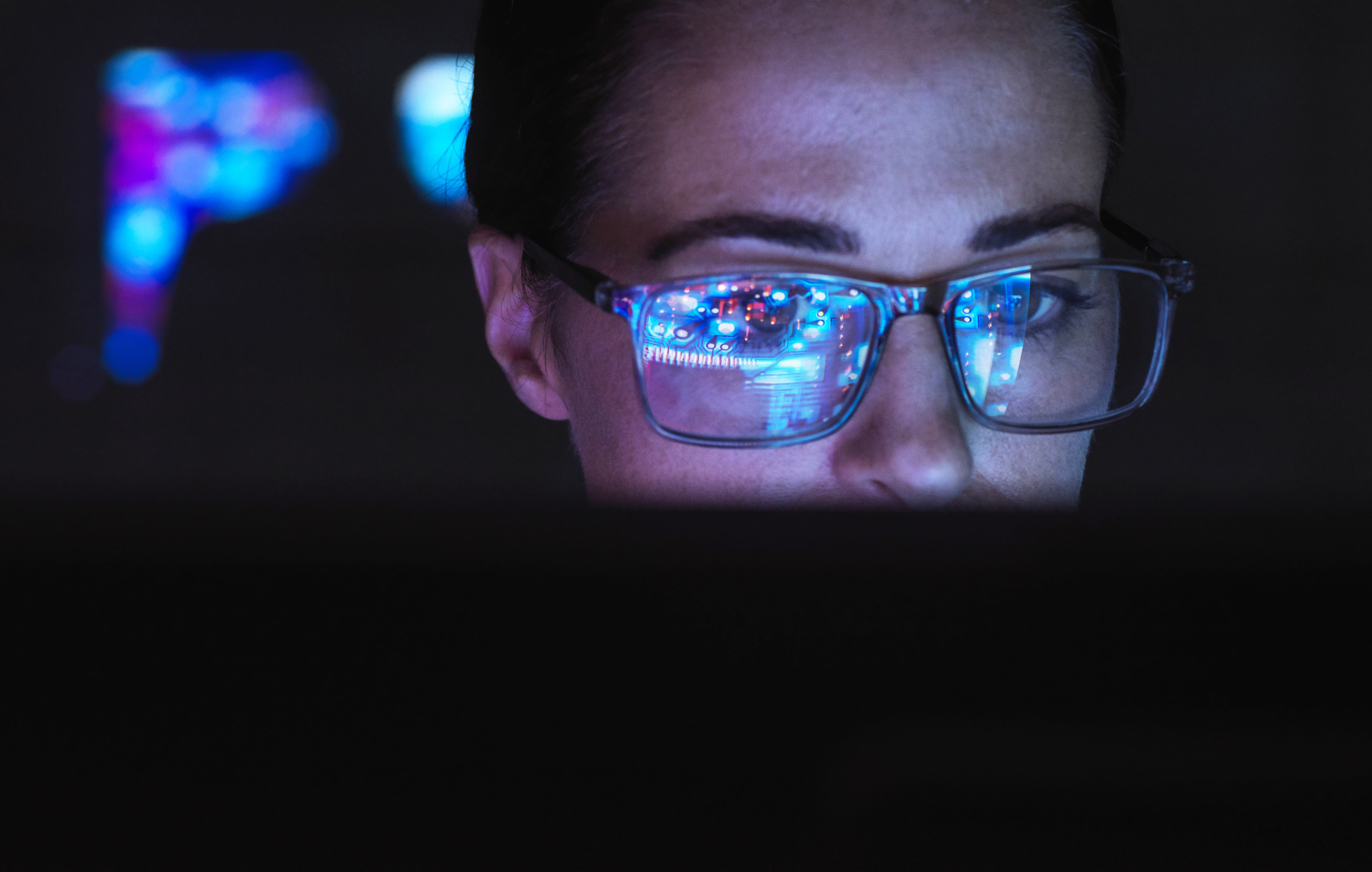 Worker uses AI on computer.