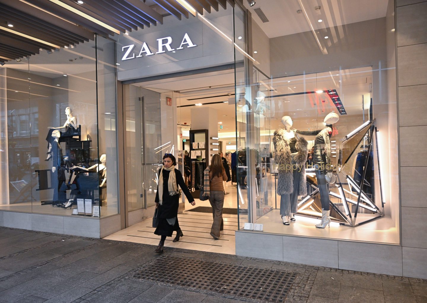 person carrying zara shopping bags