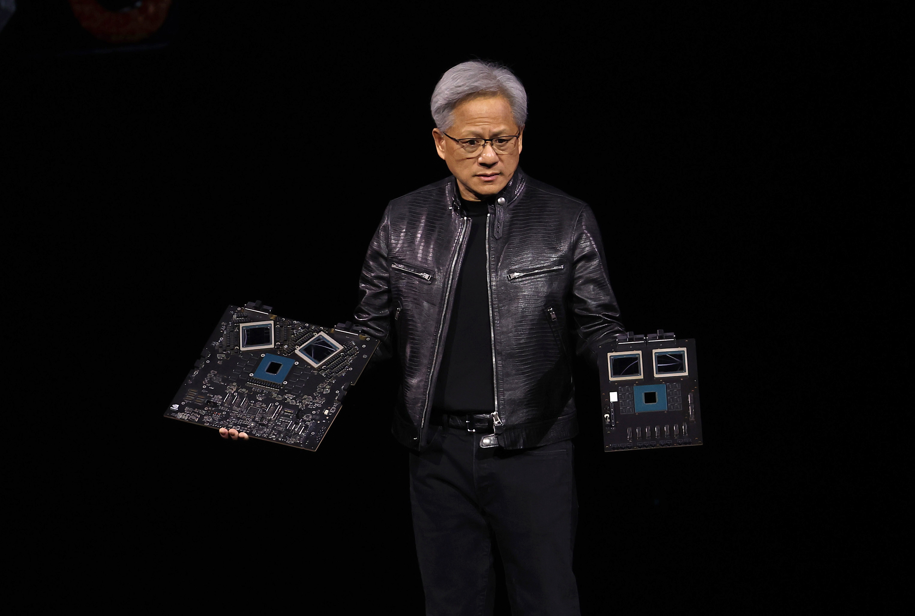 Nvidia CEO Jensen Huang holding the company's latest GB200 system.