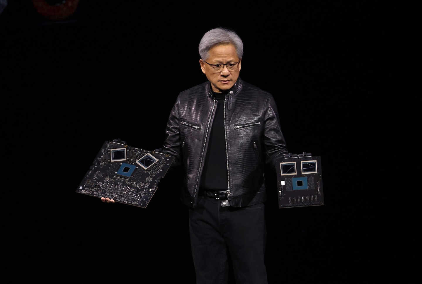Nvidia CEO Jensen Huang holding the company's latest GB200 system.