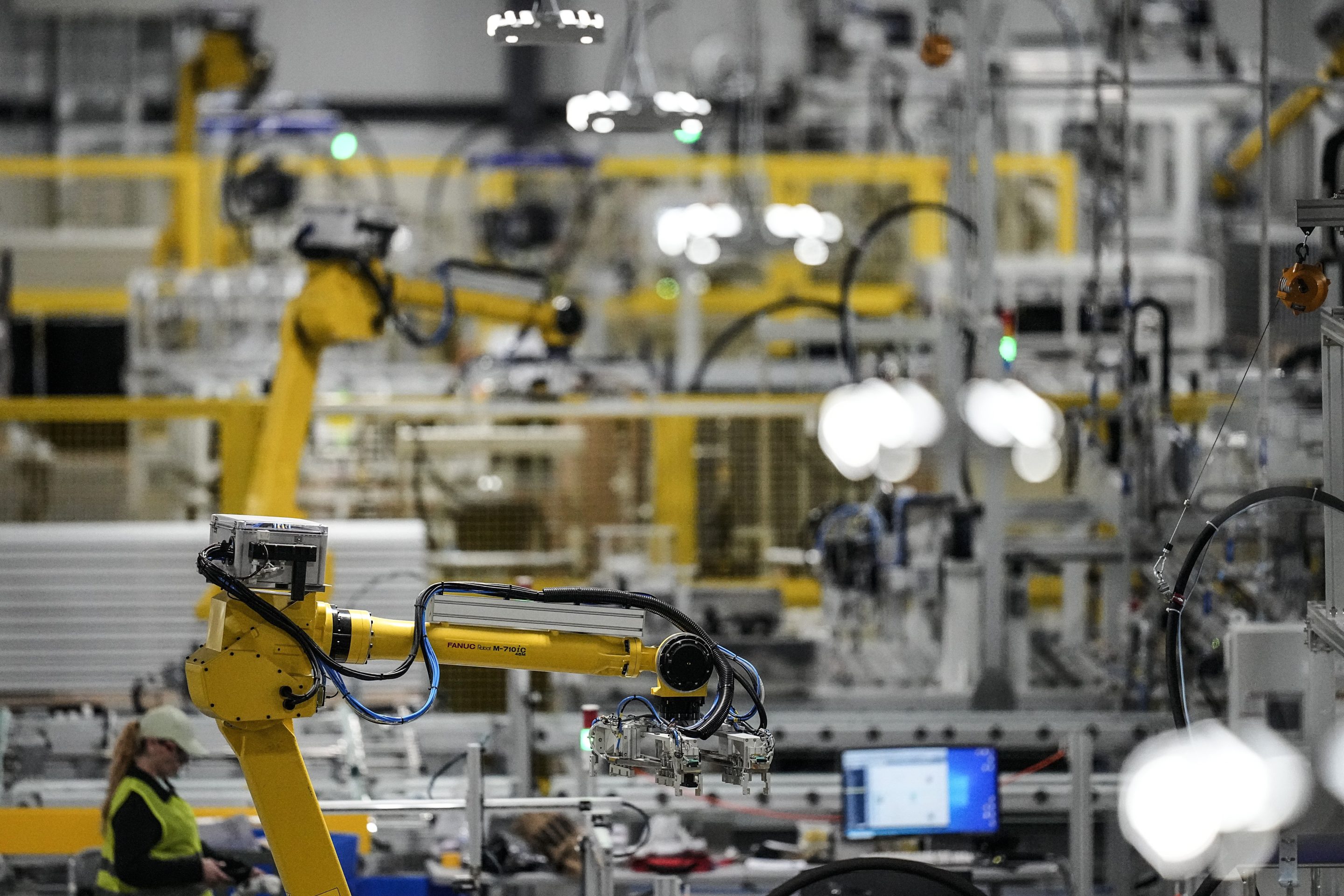 Articulated robots move inside the Hanwha Qcells Solar plant, Oct. 16, 2023, in Dalton, Ga.
