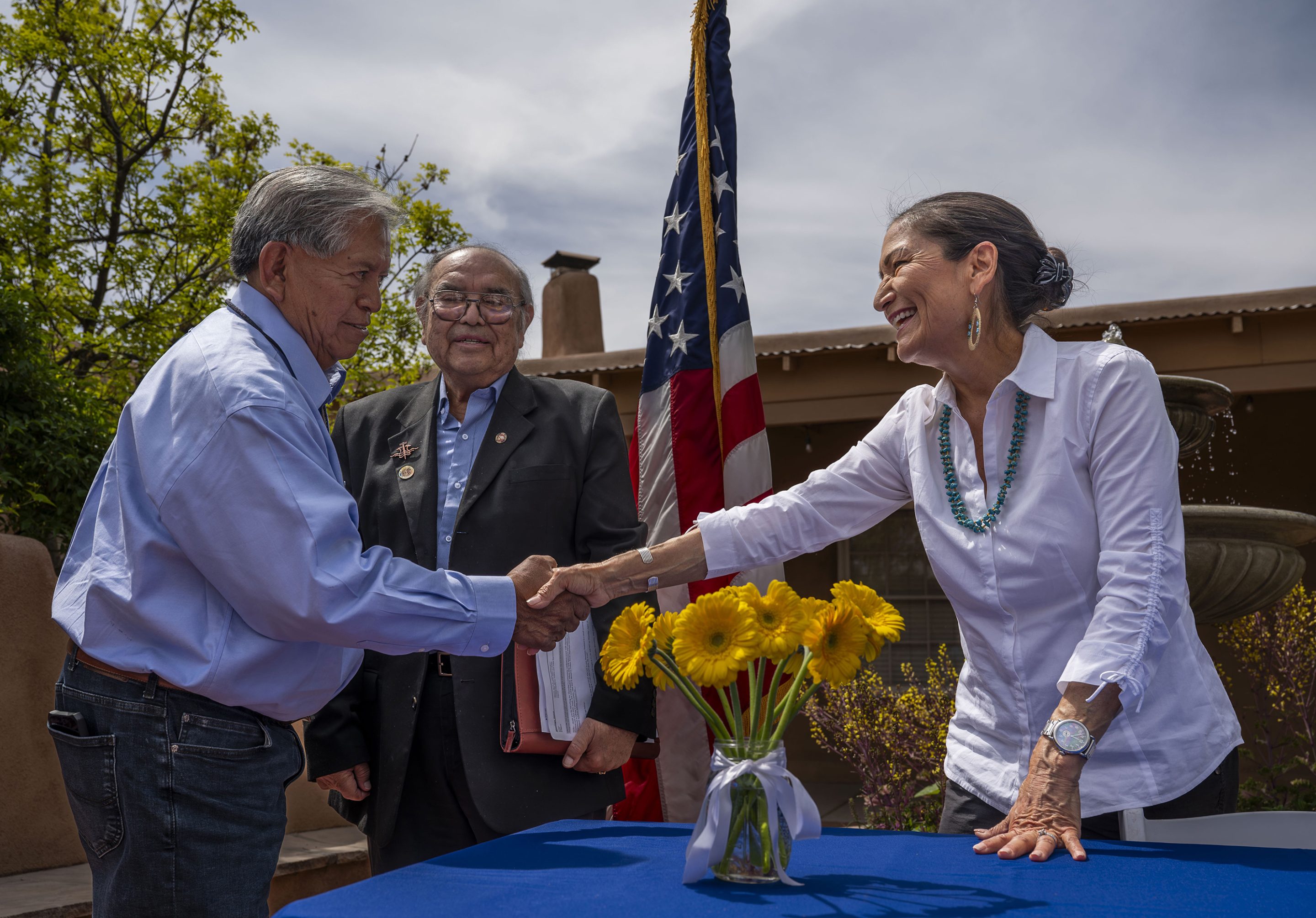 Interior Secretary Deb Haaland shakes hands with Gov. Myron Armijo of Santa Ana Pueblo after signing Public Land Order 7940, which protects more than 4,200 acres of Bureau of Land Management-managed public lands that is sacred to Tribes in the Placitas area, during a community event at El Zócalo Plaza in Bernalillo, N.M., on April 18, 2024.