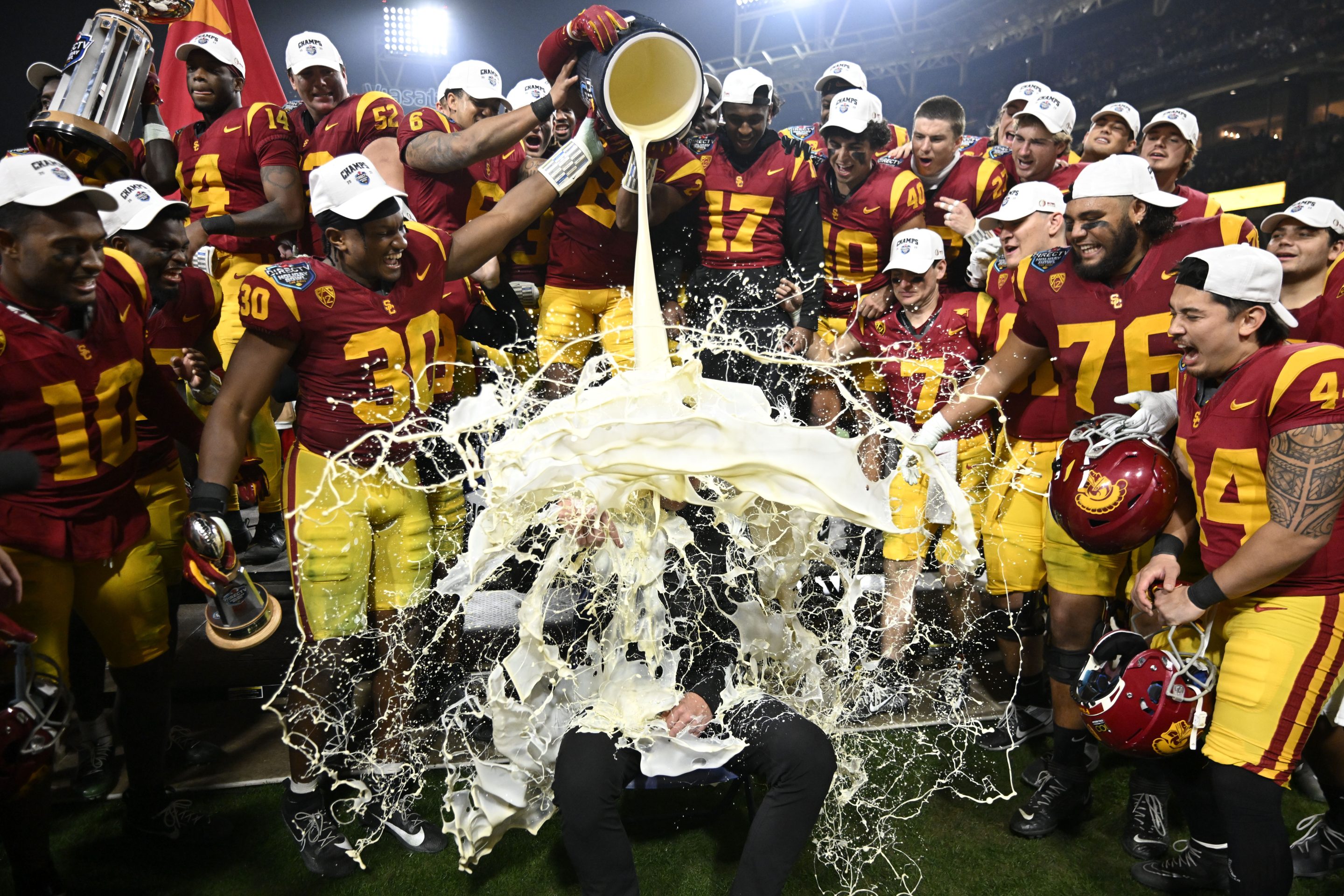 USC coach Lincoln Riley has eggnog poured onto him after his team defeated Louisville in the Holiday Bowl NCAA college football game, on Dec. 27, 2023, in San Diego.