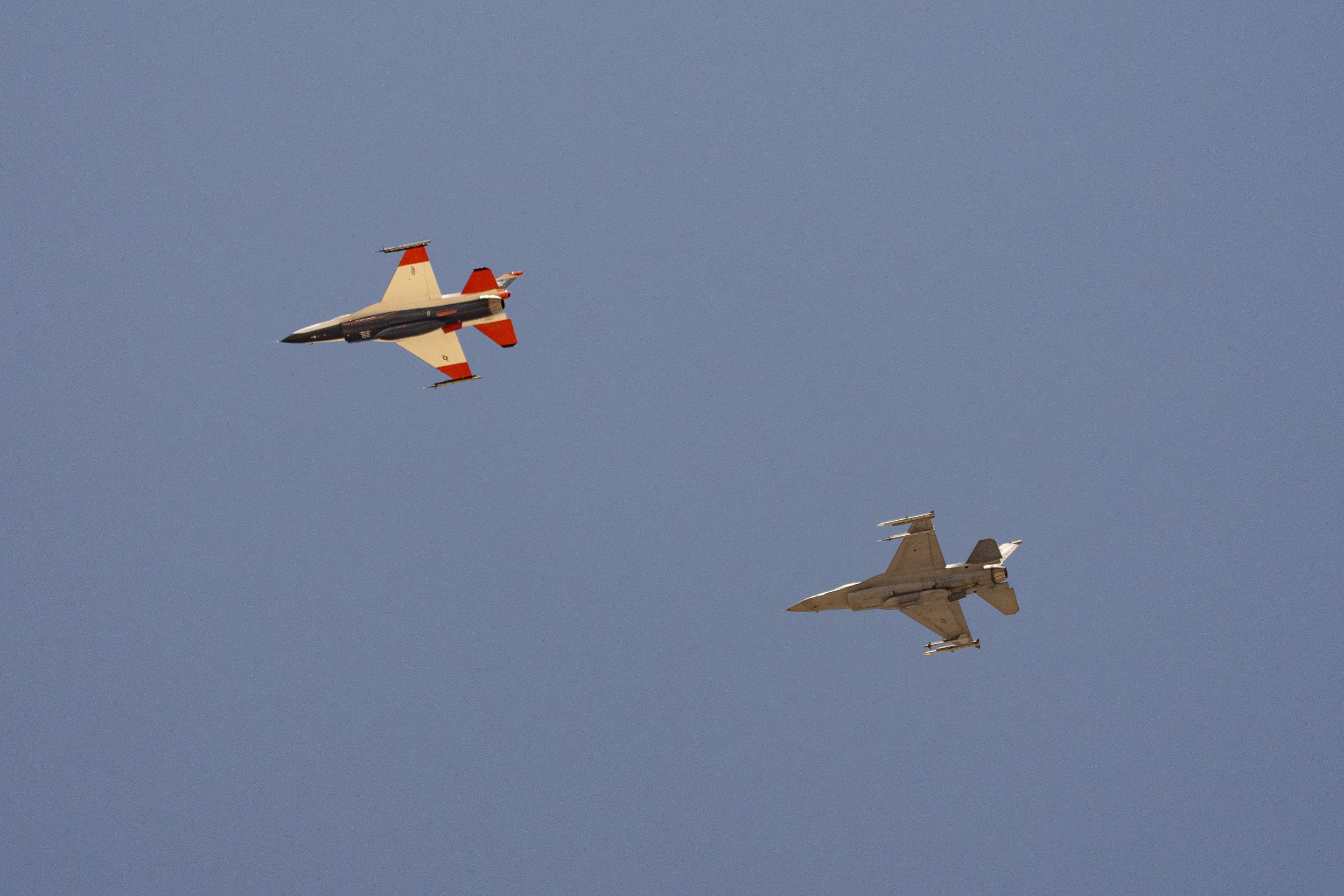 two F-16s fly next to each other