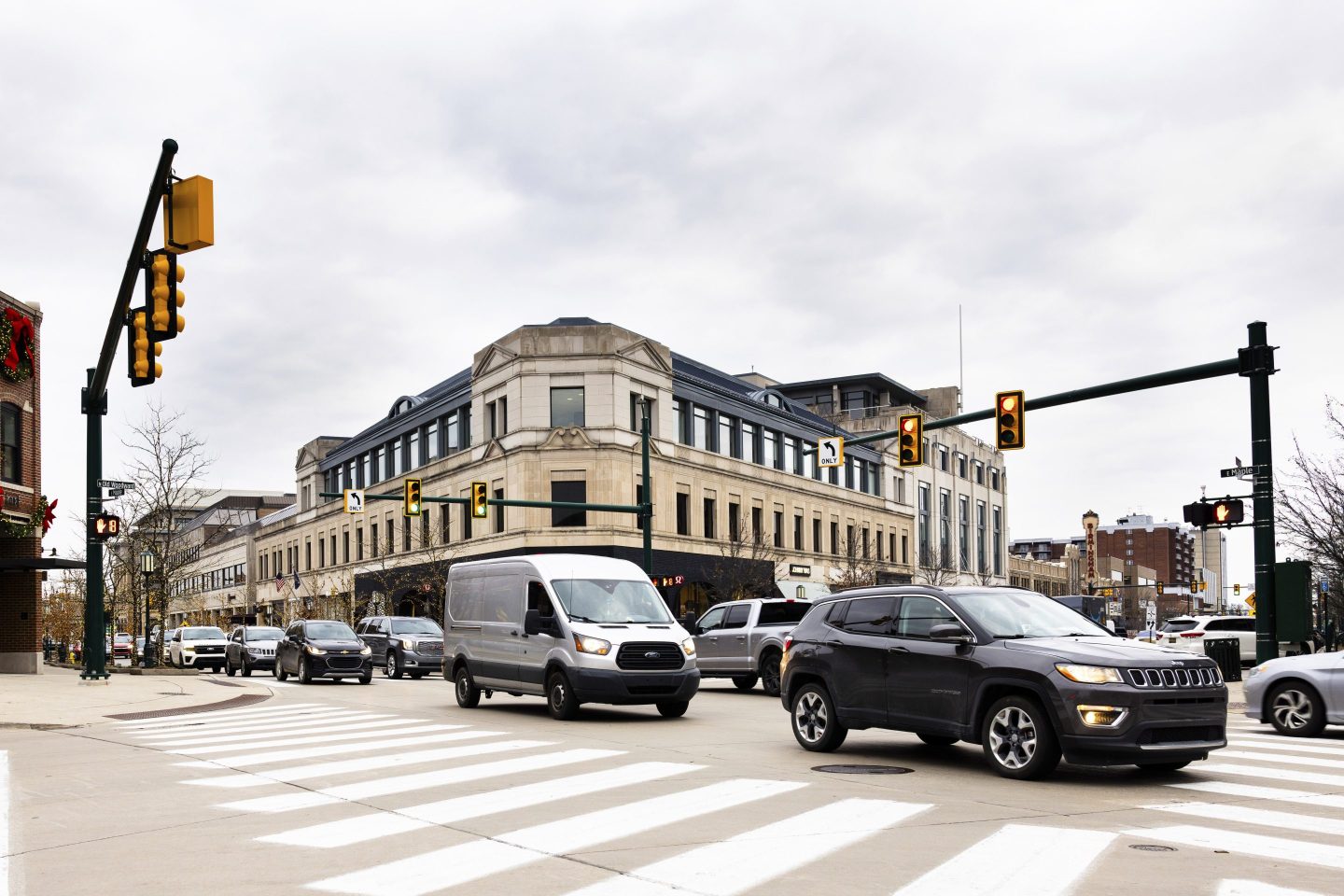 cars drive through intersection
