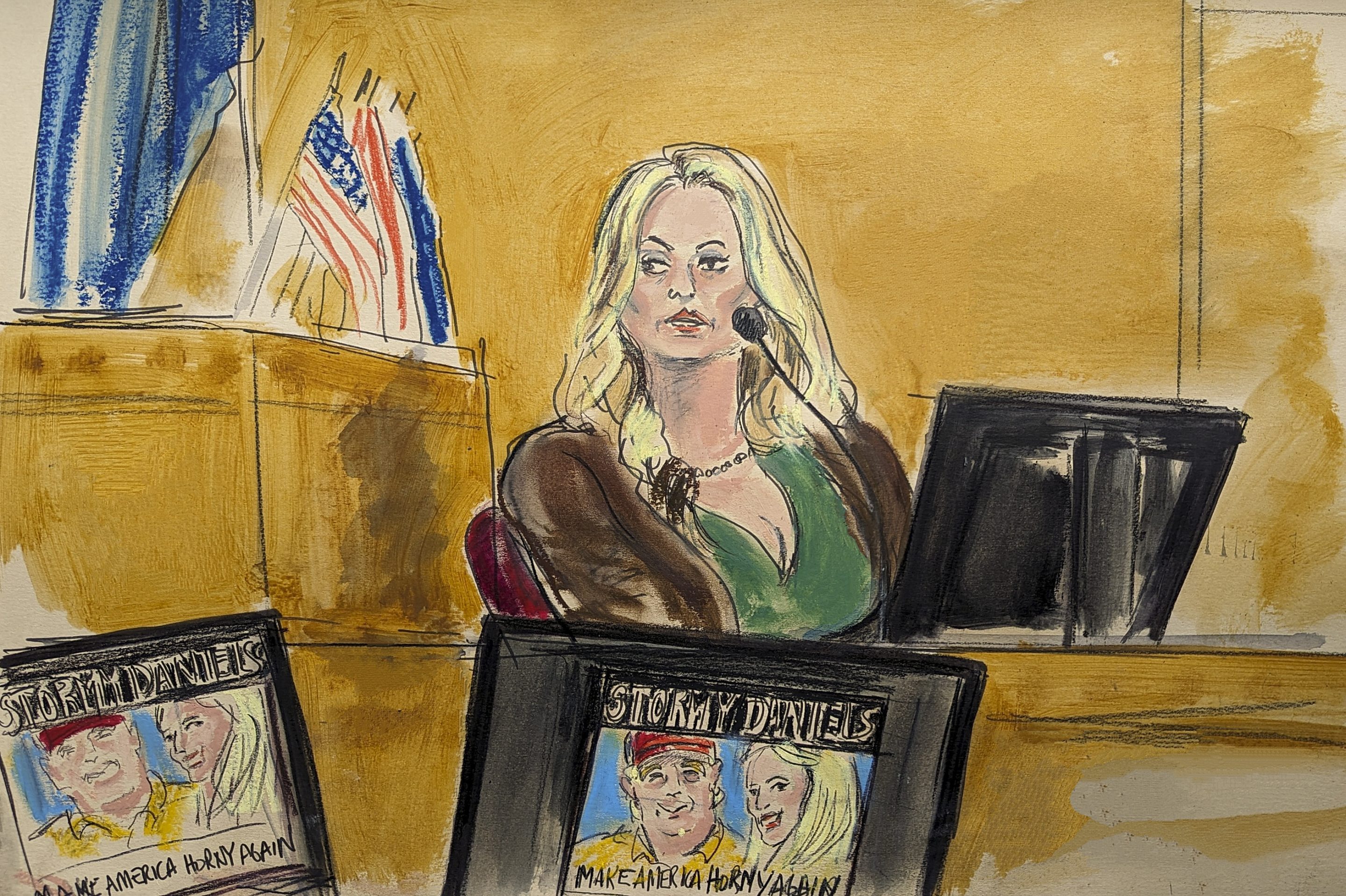 Stormy Daniels testifies on the witness stand as a promotional image for one of her shows featuring an image of Trump is displayed on monitors in Manhattan criminal court, on May 9, 2024, in New York.