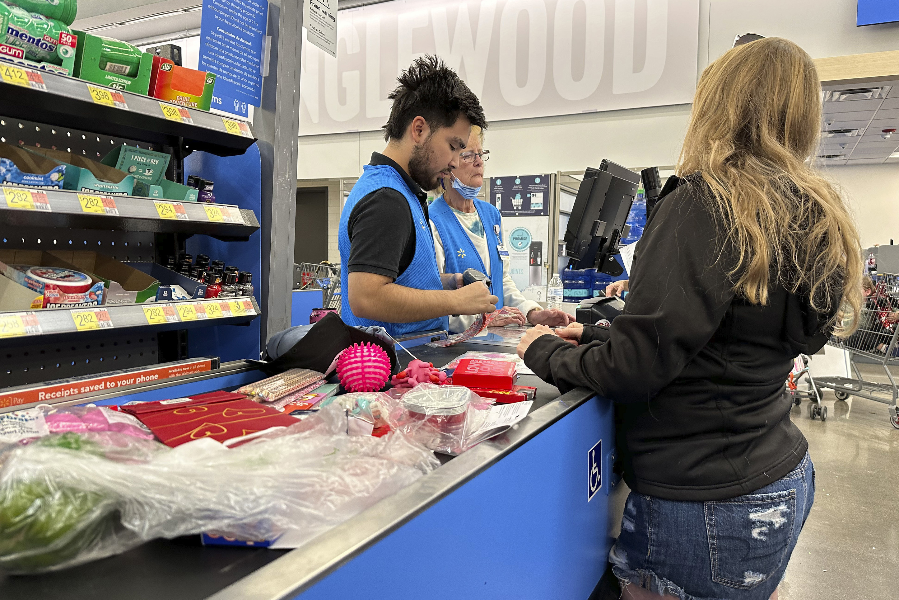 A customer checks out of a Walmart store in Englewood, Colo.