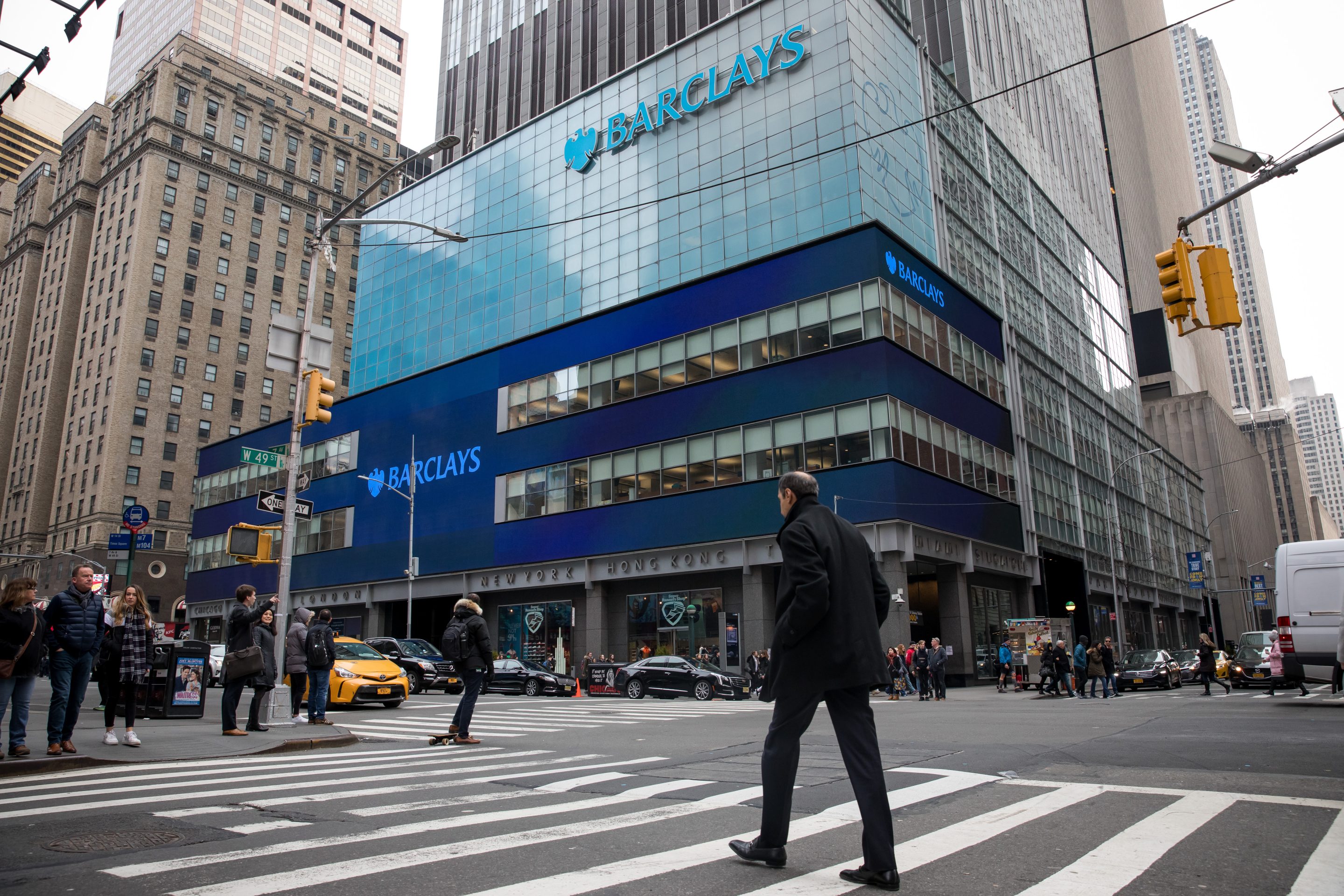Pedestrians pass in front of Barclays PLC headquarters in New York, on Feb. 22, 2019. 