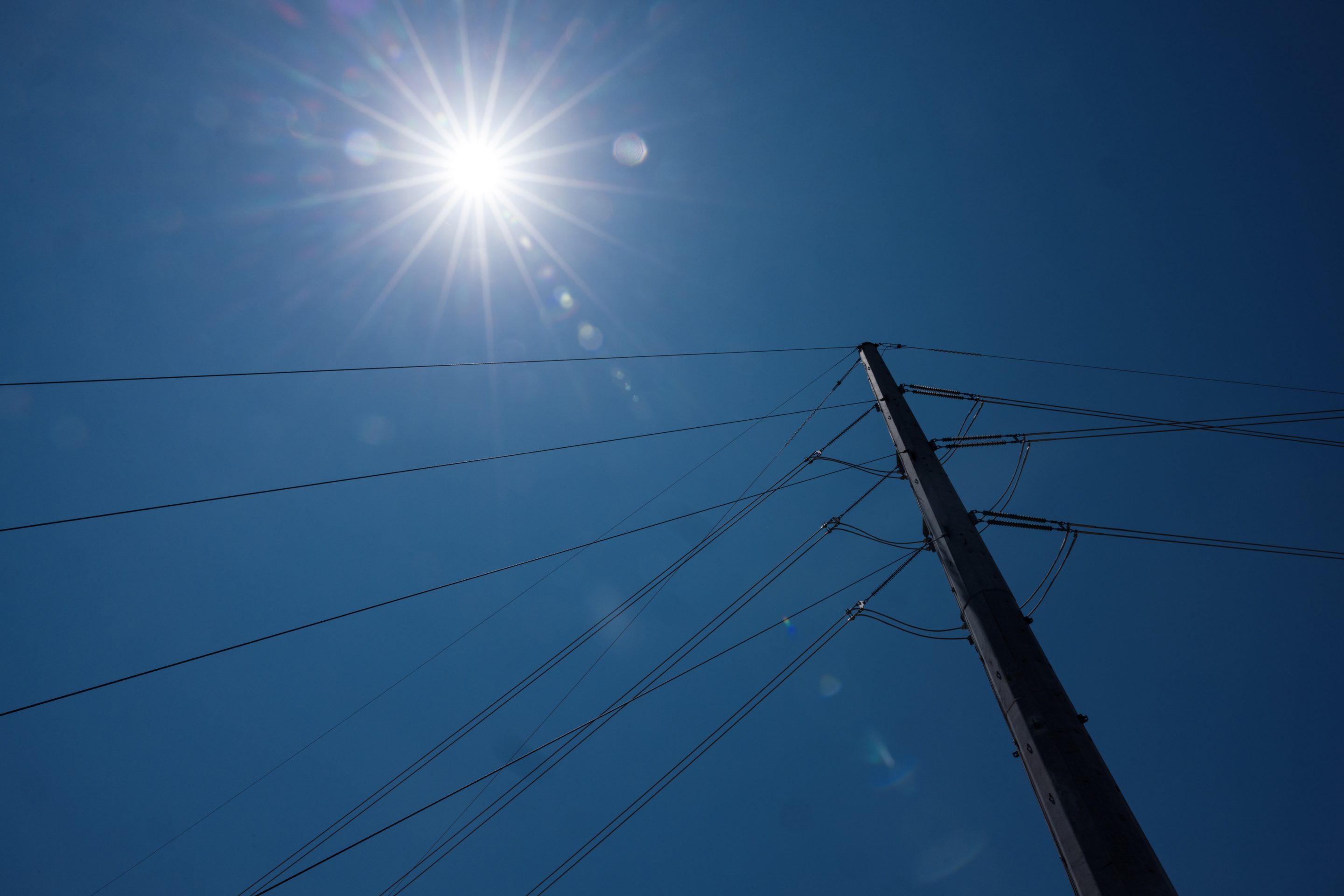 sun shines on power lines