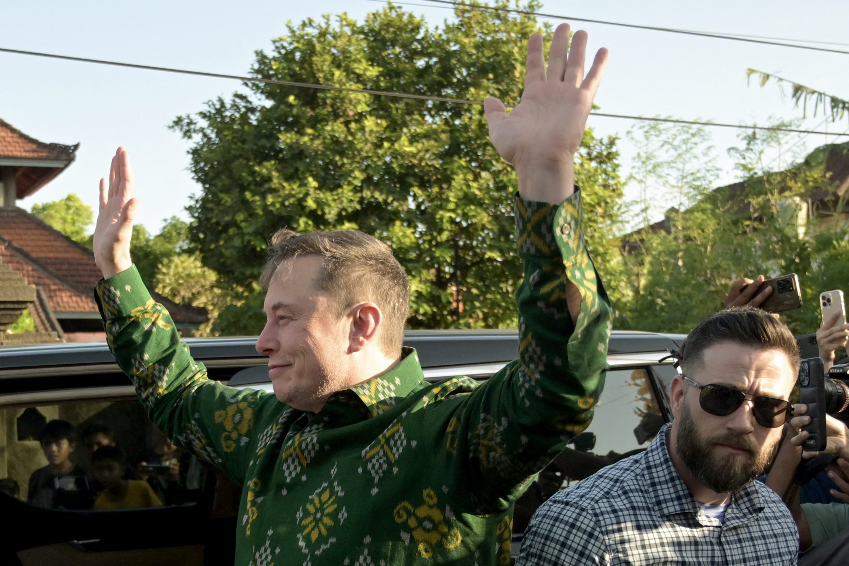 Elon Musk waves to crowd