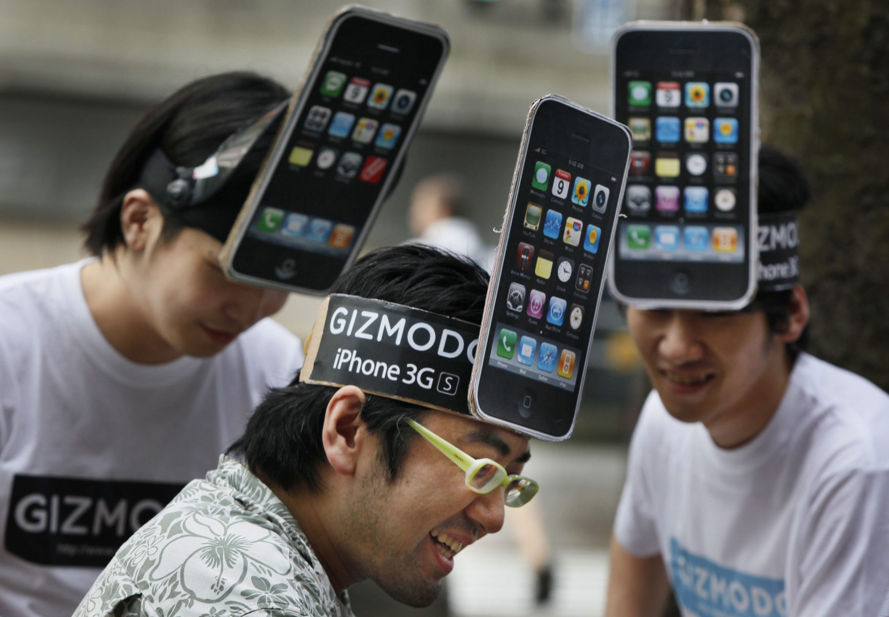 iPhone fans share a light moment while waiting for the first day sales of iPhone 3GS in Tokyo, Japan, on June 26, 2009. 