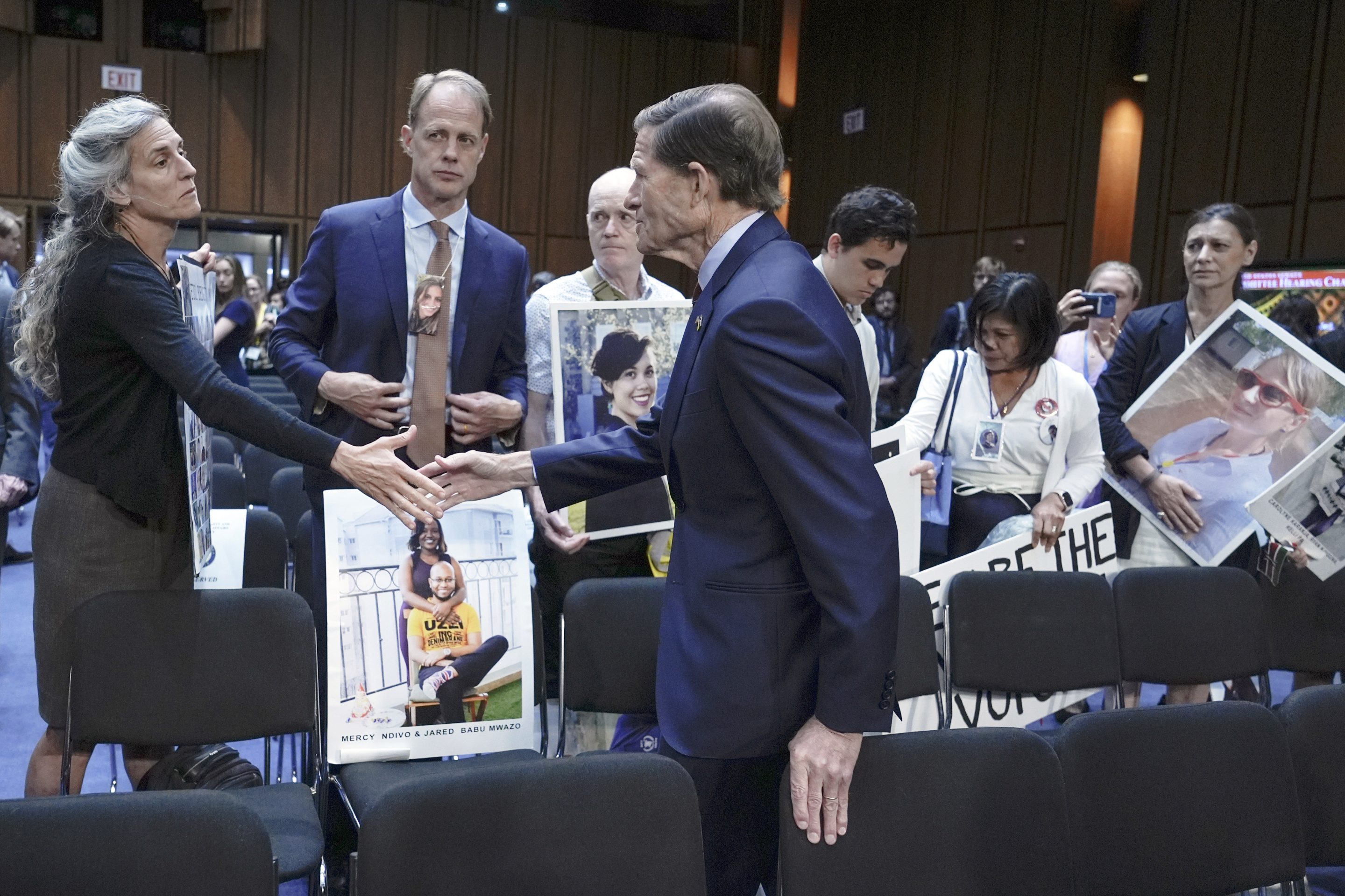 Sen. Richard Blumenthal, D-Conn., center, visits with family members of victims of Boeing plane crashes after a Senate Homeland Security Subcommittee on Investigations hearing on Capitol Hill on June 18, 2024, in Washington. 