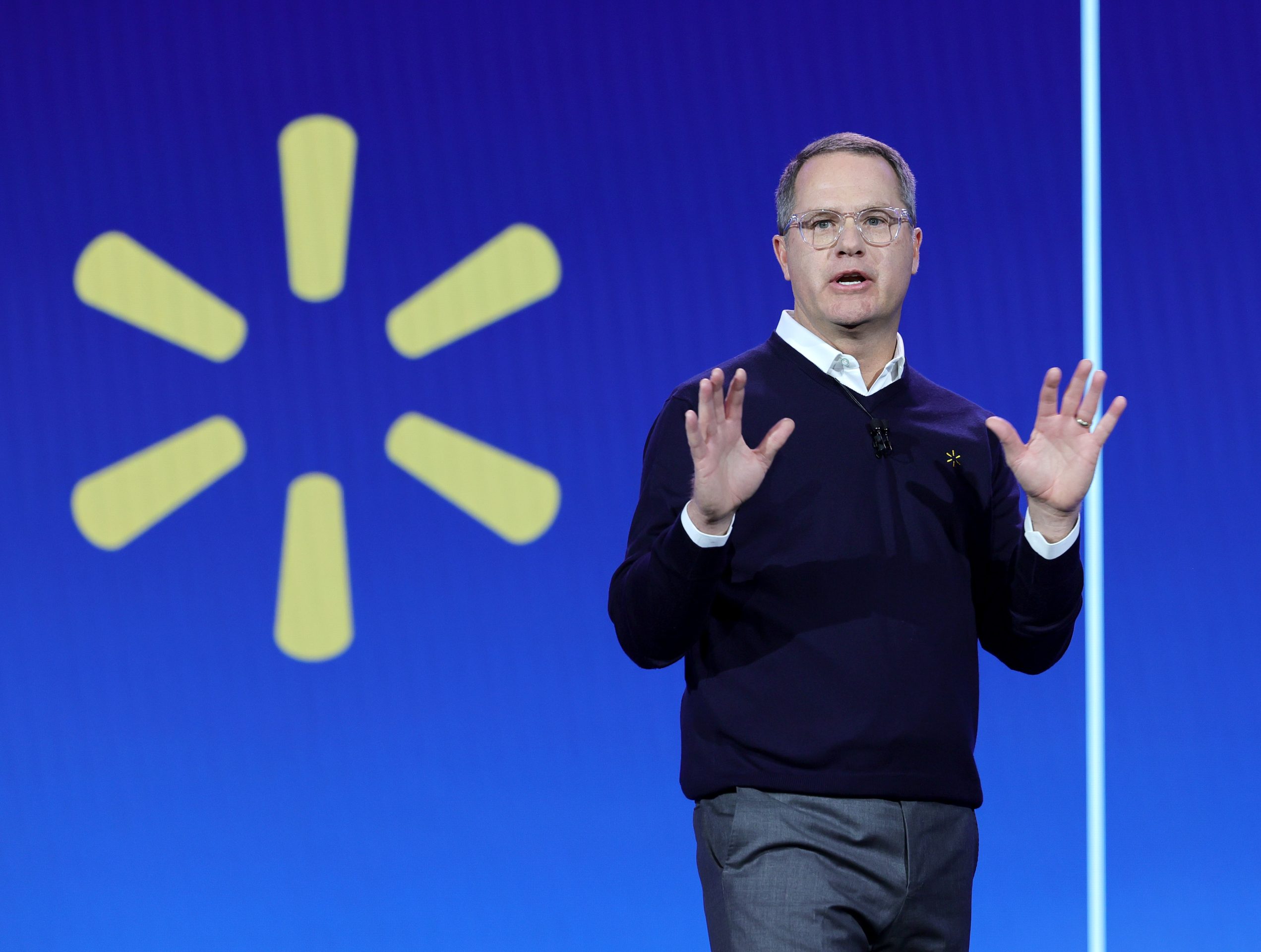 Walmart CEO Doug McMillon speaking onstage a trade show.