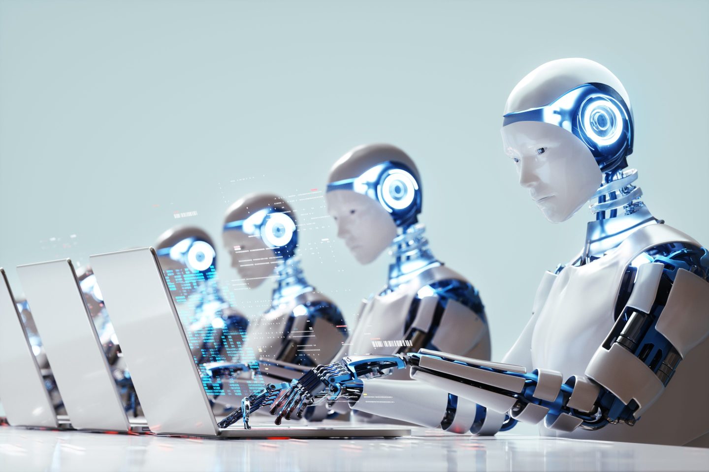 Several robots working on laptops