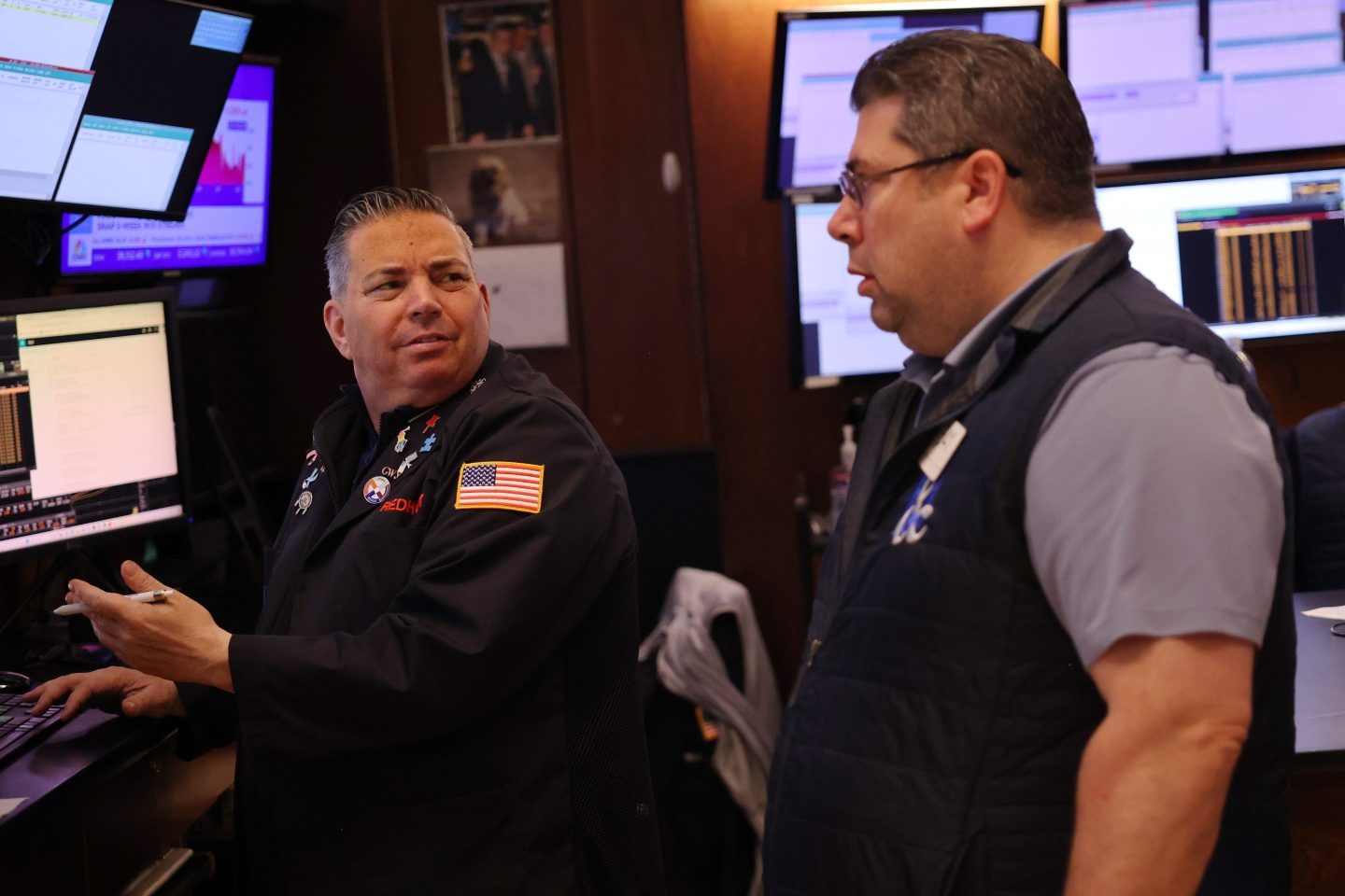 Two men look at each other on NYSE floor