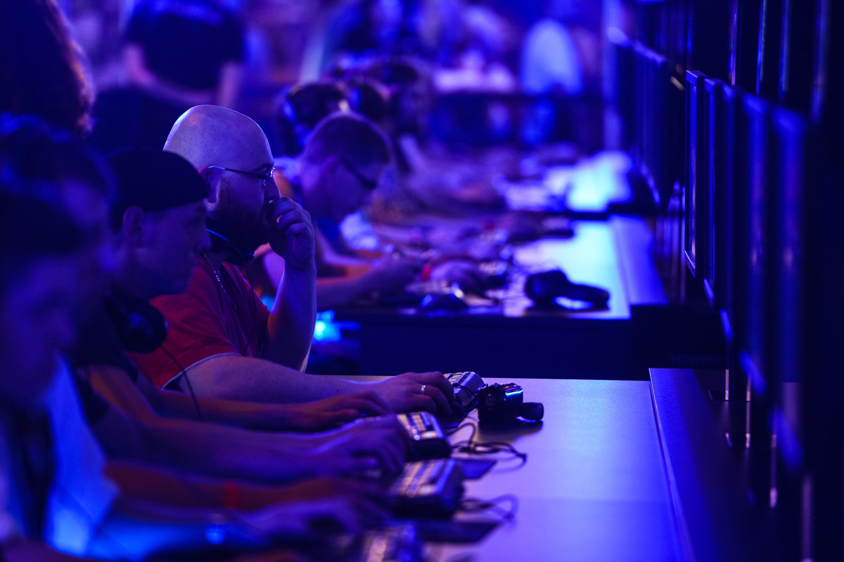 Visitors try out the massively multiplayer online role-playing game 'World Of Warcraft' at the Blizzard Entertainment stand at the Gamescom 2015 gaming trade fair.