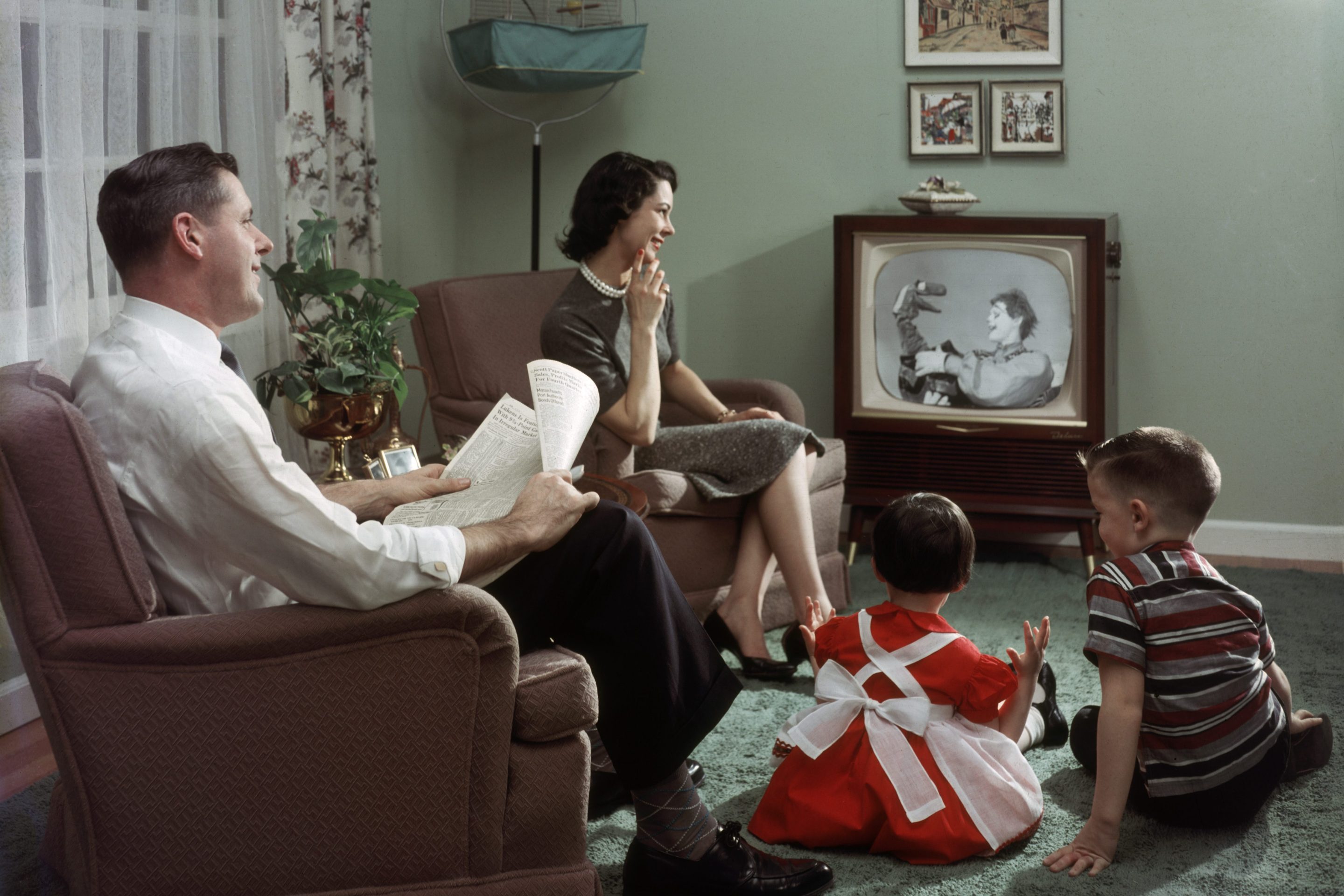 A family sits in their living room and watches a televised clown and puppet show, 1957. Deutsche Bank thinks the U.S. economy could be heading back to this bygone era.