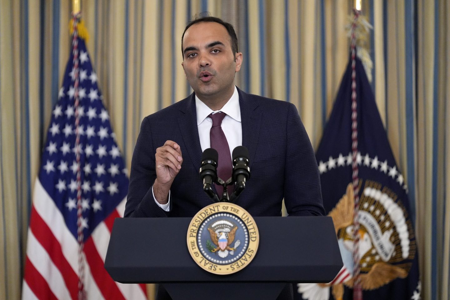Consumer Financial Protection Bureau director Rohit Chopra speaks at a podium