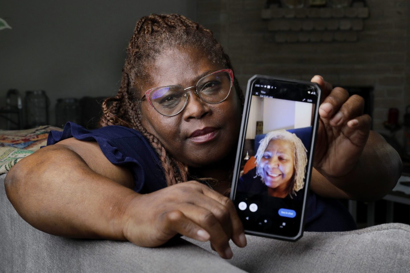 woman shows photo on her phone