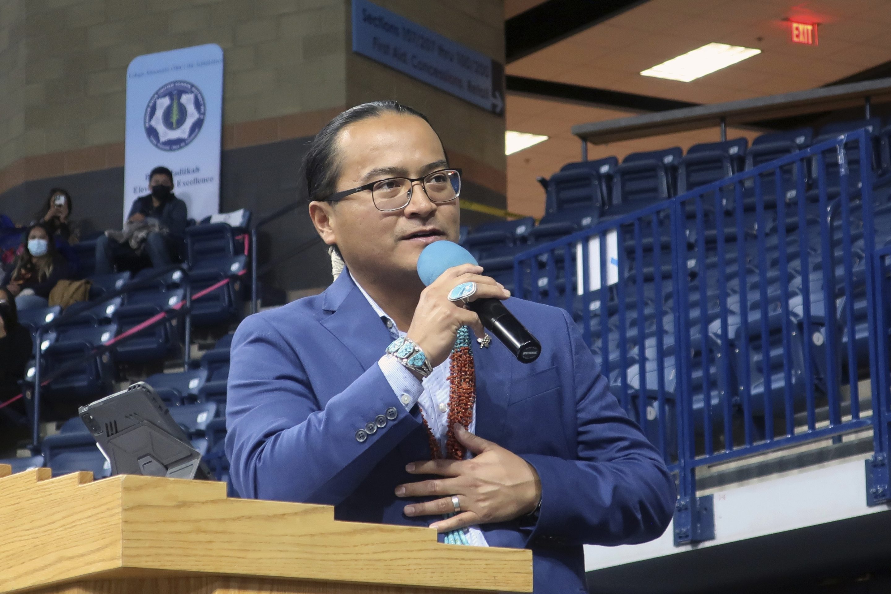 Navajo Nation President Buu Nygren addresses a crowd at an indoor sports arena, on Jan. 10, 2023, in Fort Defiance, Ariz.