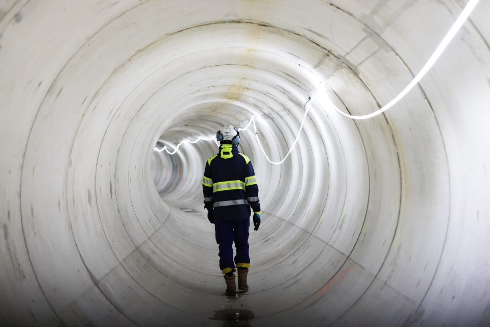 A worker walks inside the water pipeline during a press tour at the Bassin d'Austerlitz, a huge water tank which aims to clean up the Seine River