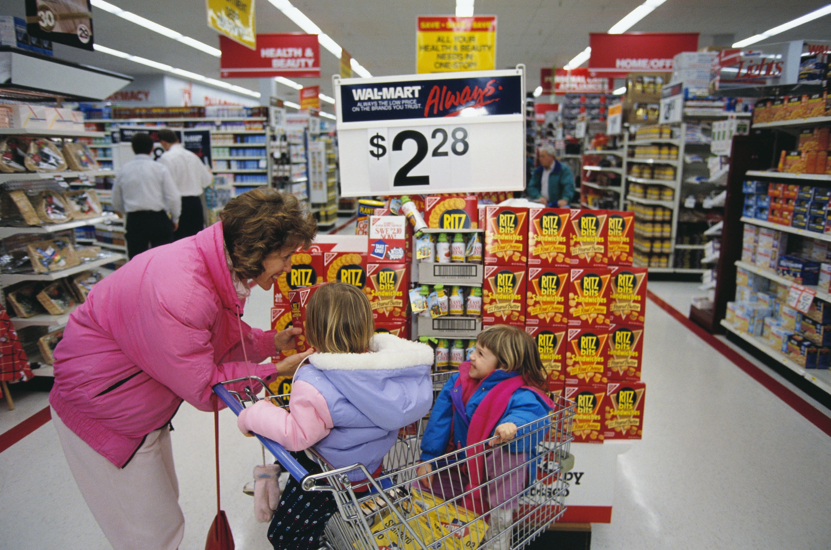 A woman and two children shop at a Wal-Mart store in the early 1990s.