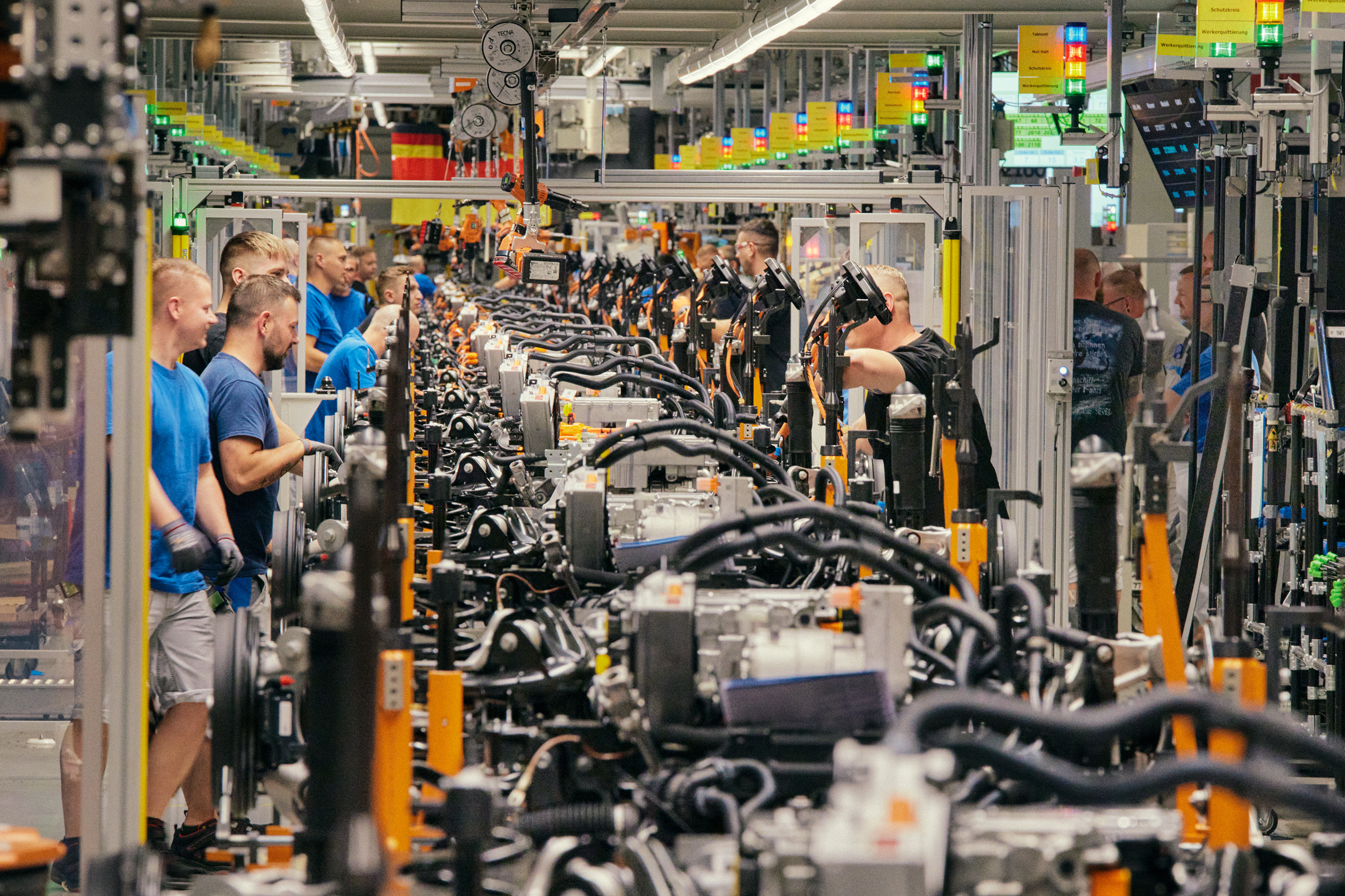 Workers assemble EVs at a retrofitted Volkswagen plant in Zwickau, Germany that used to produce VW Golfs.