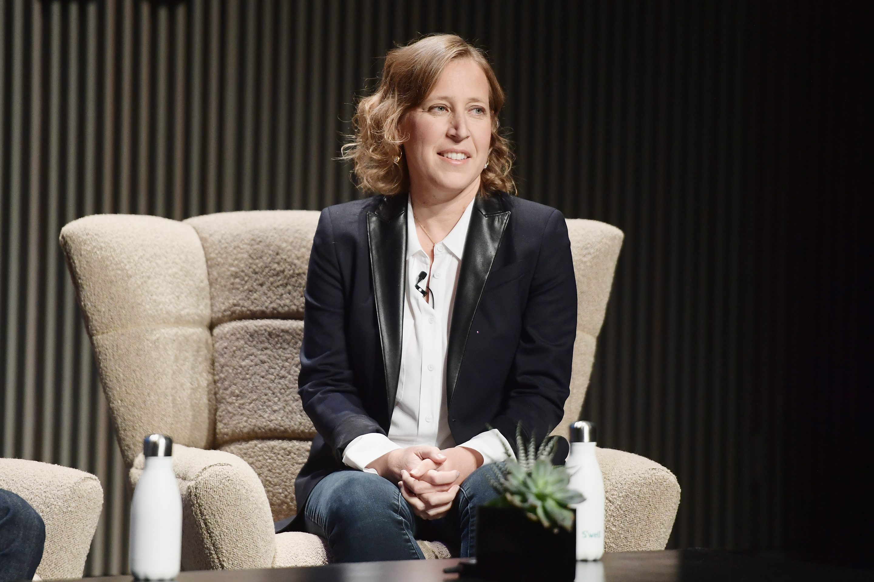 woman in professional attire speaking onstage