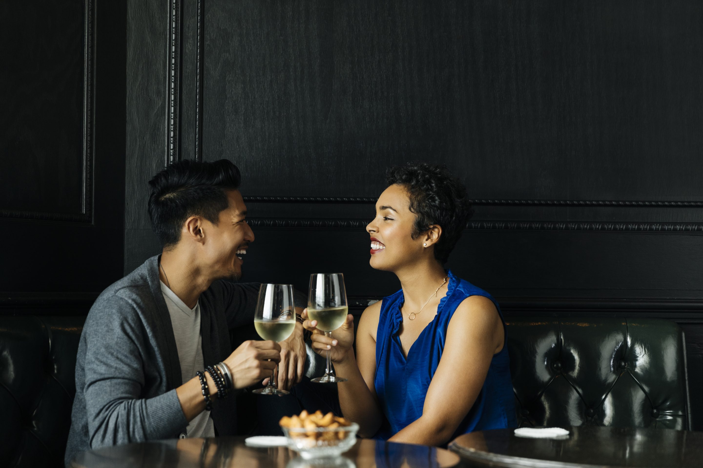 Couple toasting wine glasses at restuarant