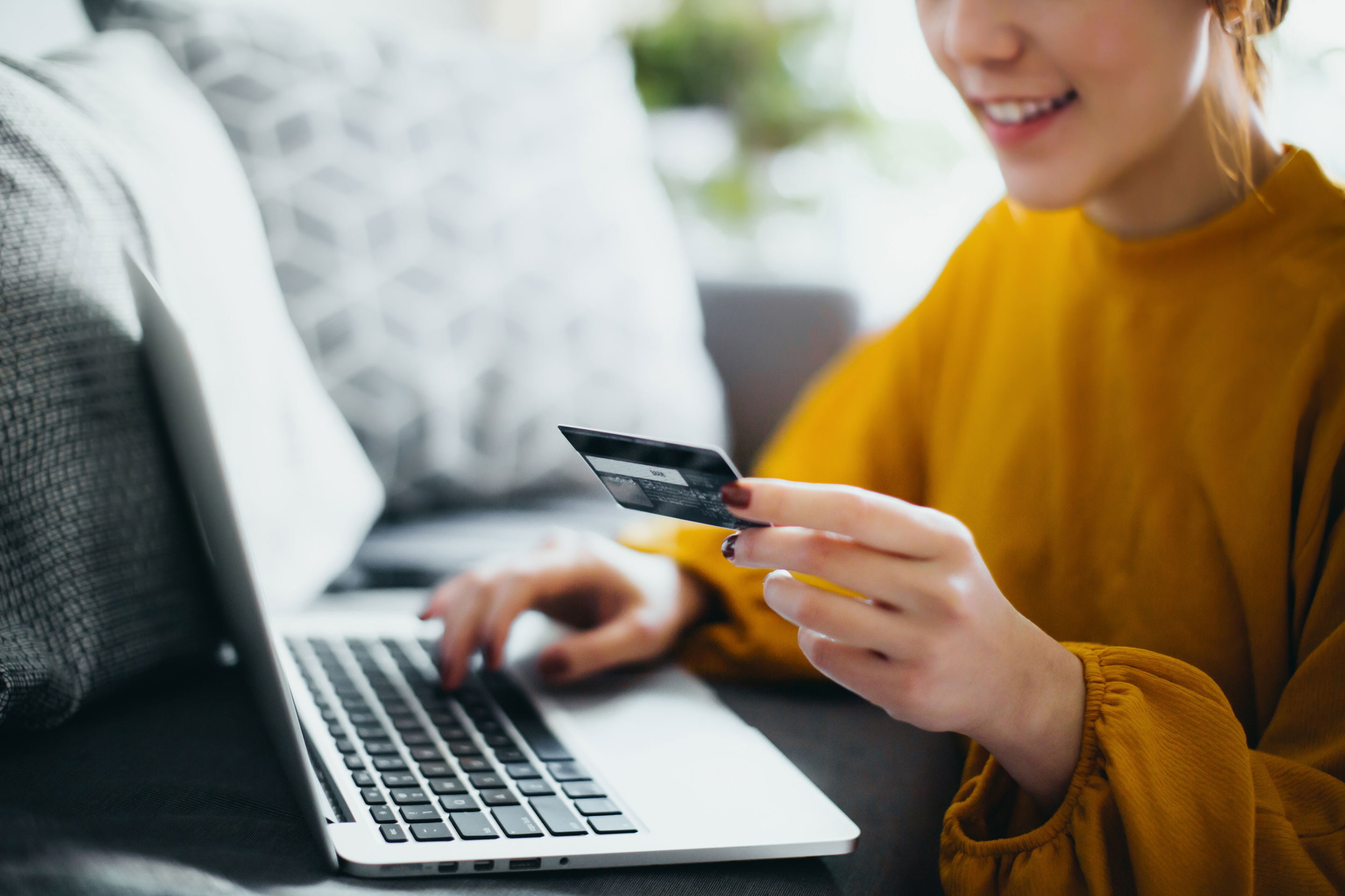 Asian woman making payments online with a credit card