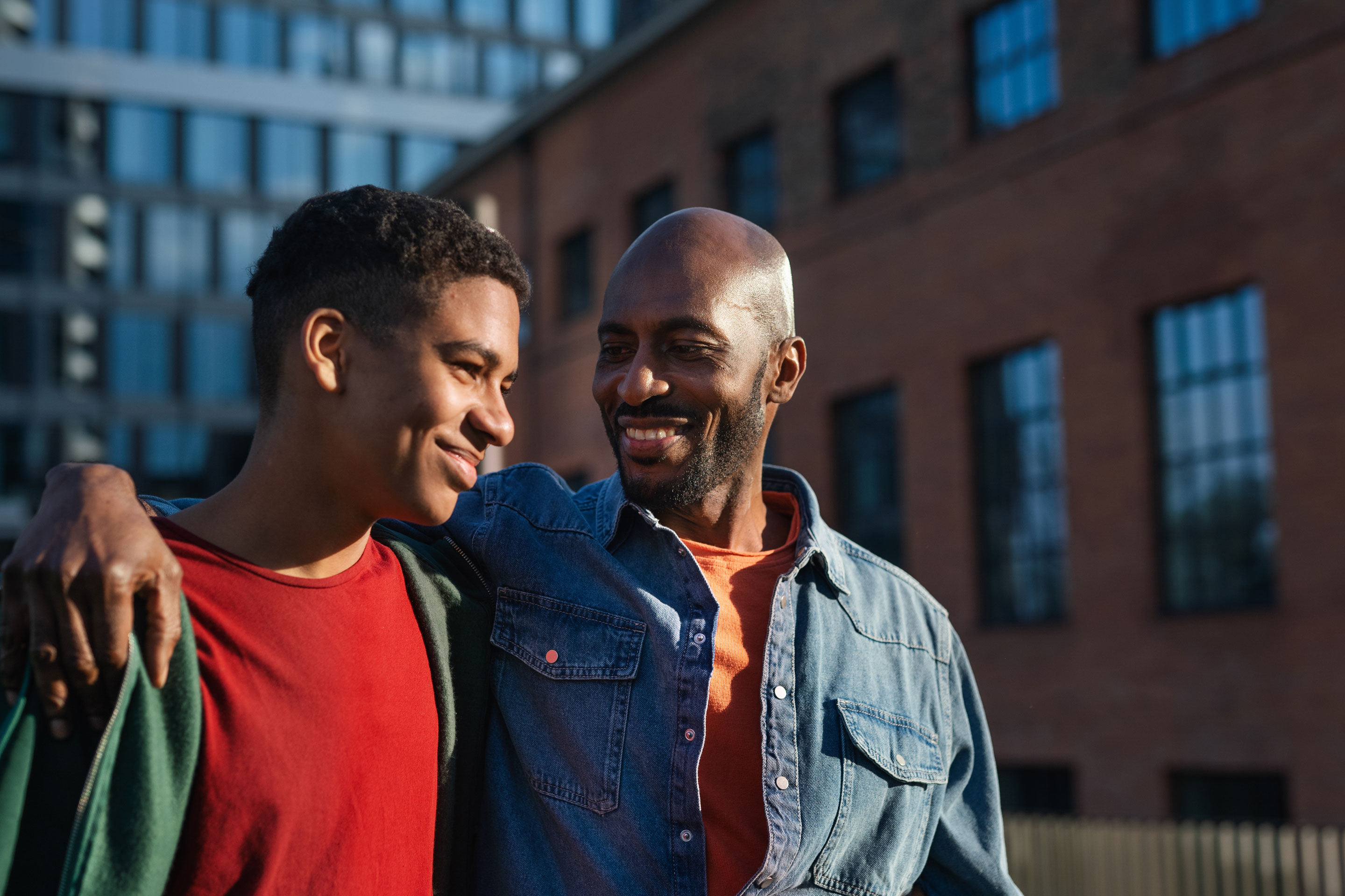 Father walking with his teenage son in a city