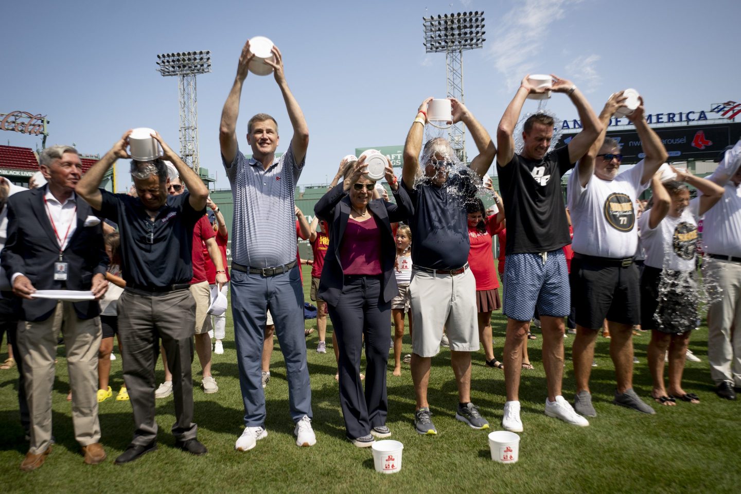 Boston Red Sox President and CEO Sam Kennedy, Governor Maura Healey, and former NFL quarterback Matt Ryan, amongst others, participate in the 10th anniversary of the Frates Foundation Ice Bucket Challenge August 1, 2024, at Fenway Park in Boston, Massachusetts. 