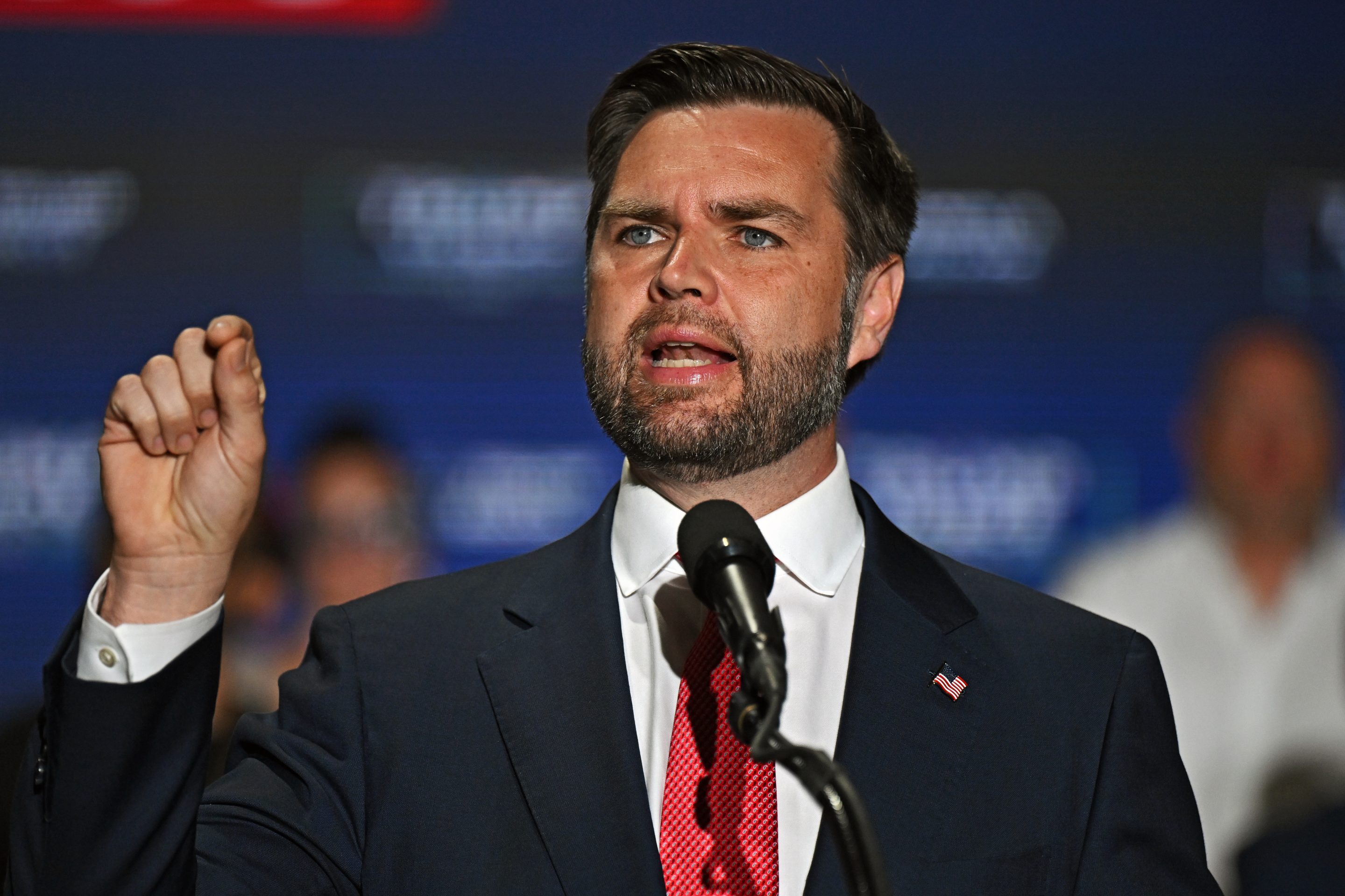 JD Vance holds up hand