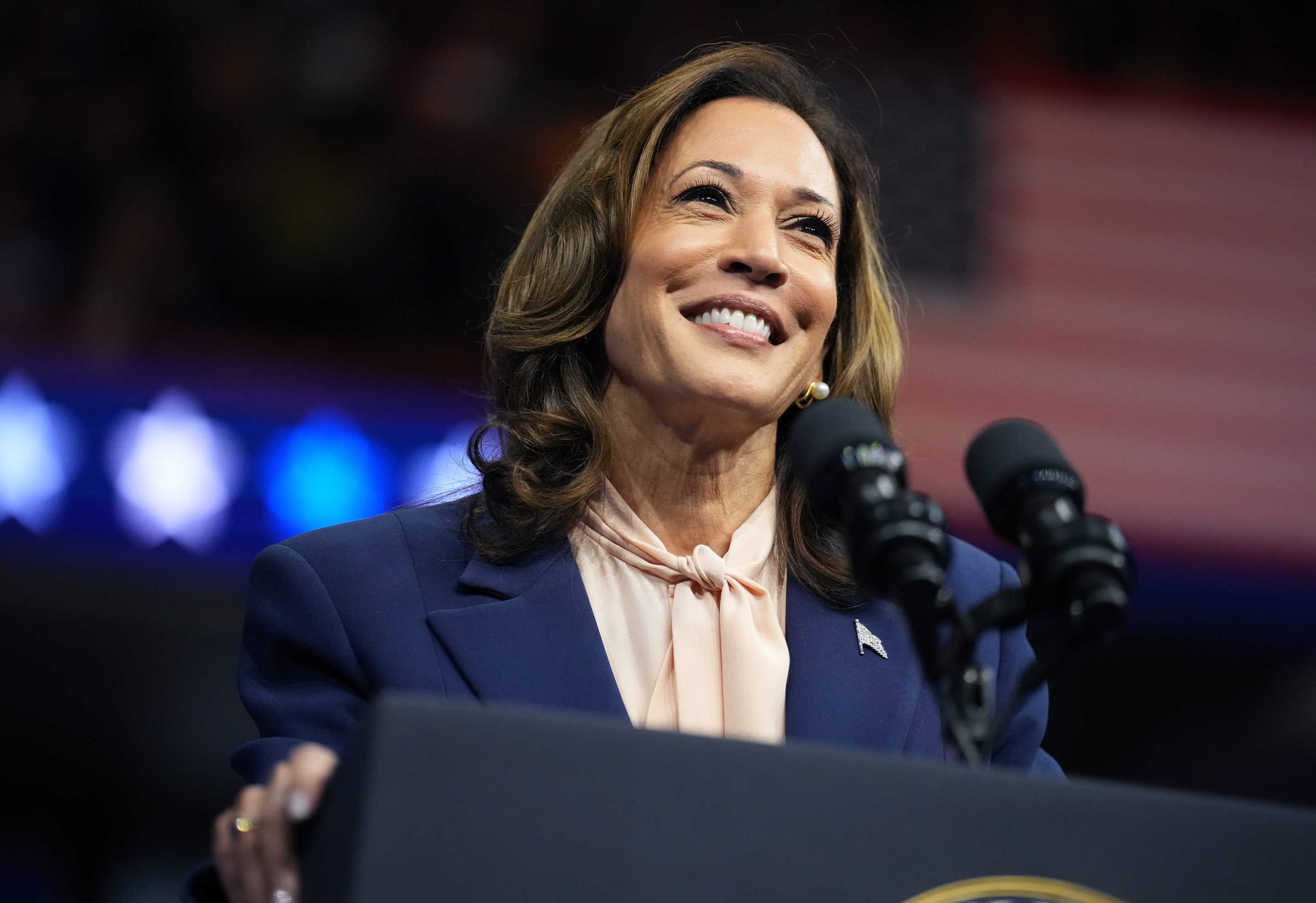 Kamala Harris smiling at a podium