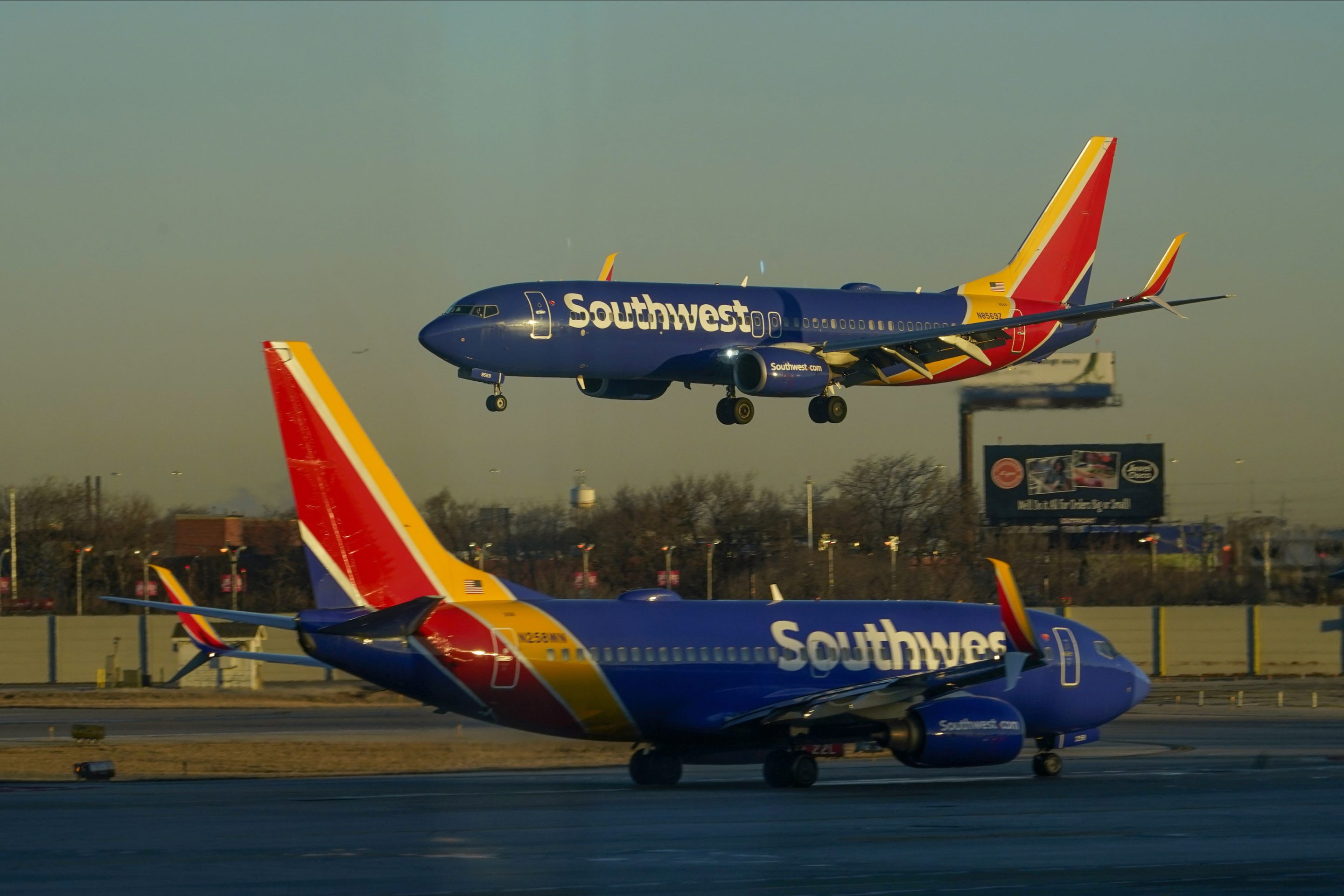 A Southwest Airlines plane prepares to land at Midway International Airport while another taxis on the ground, Feb. 12, 2023, in Chicago.
