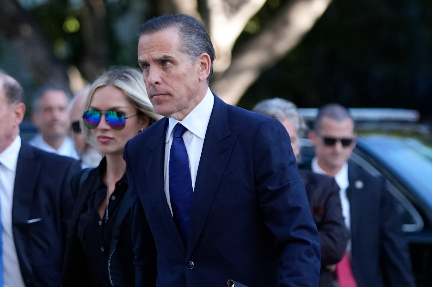 Hunter Biden is pictured outside the court room wearing a dark navy suit and tie.