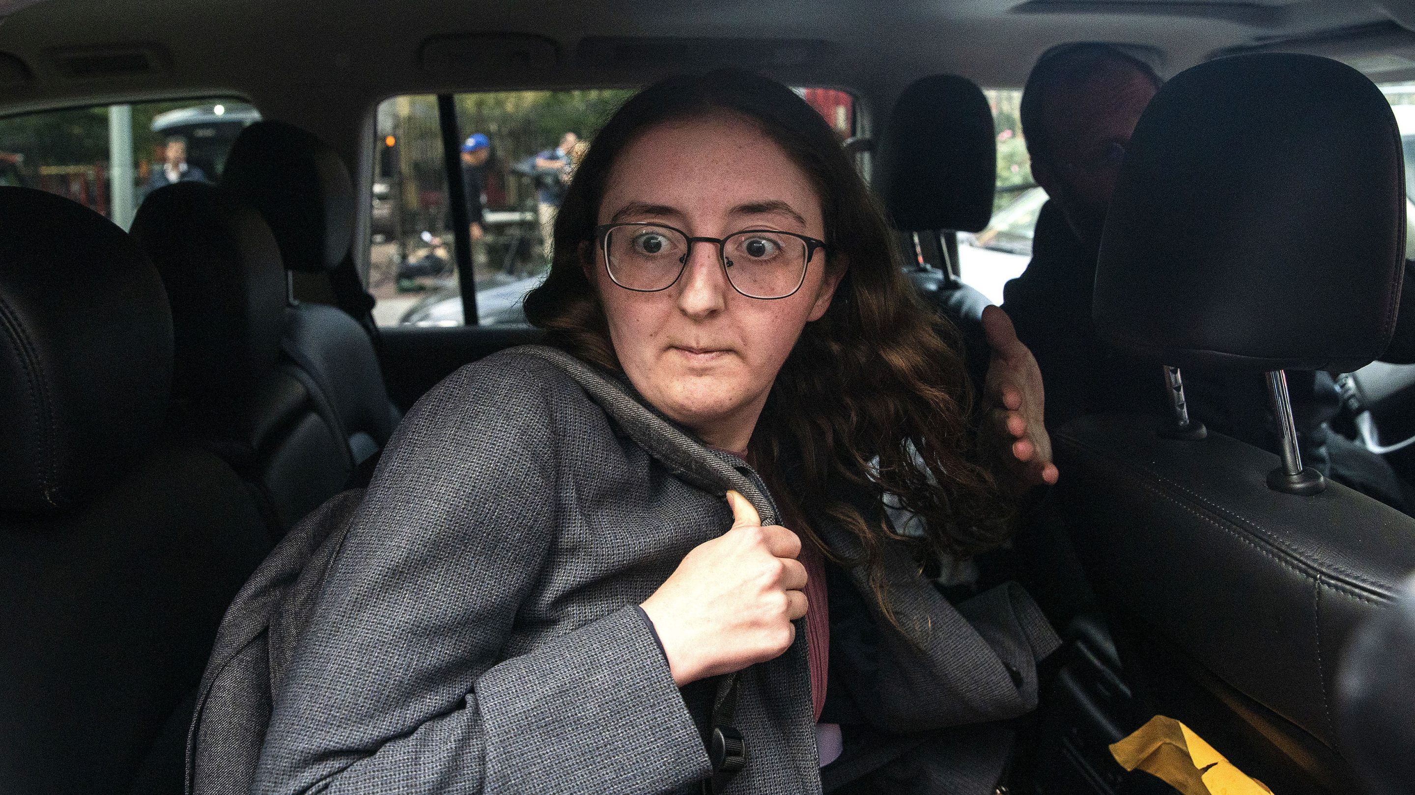Caroline Ellison is seen getting out of a car at a court appearance.