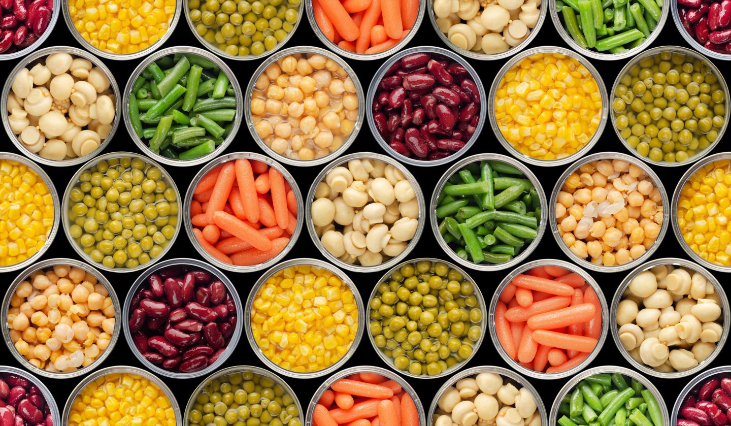 Opened canned food with various veggies and legumes featured.