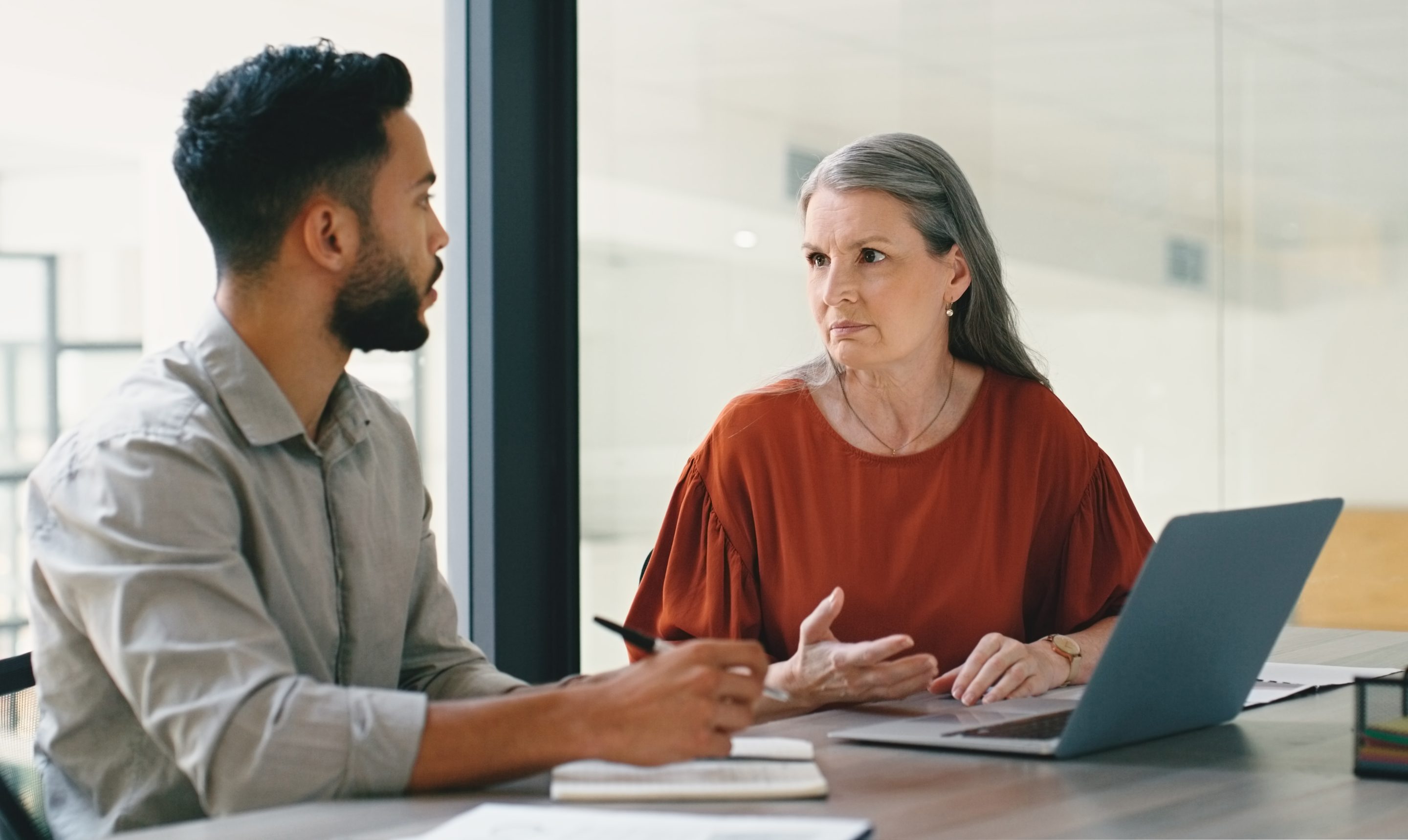 Woman and man chat at work.