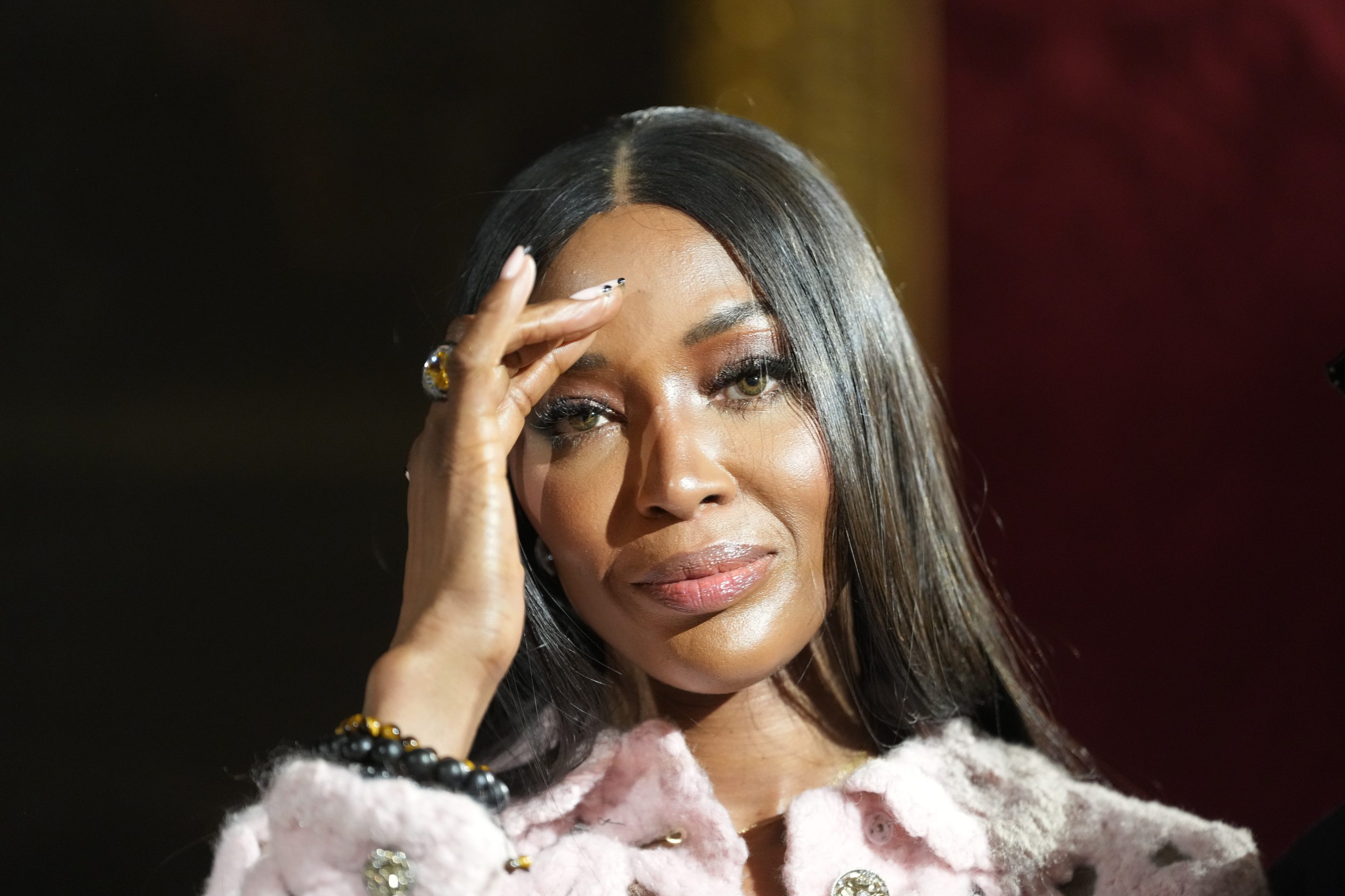Supermodel Naomi Campbell pushing back her hair