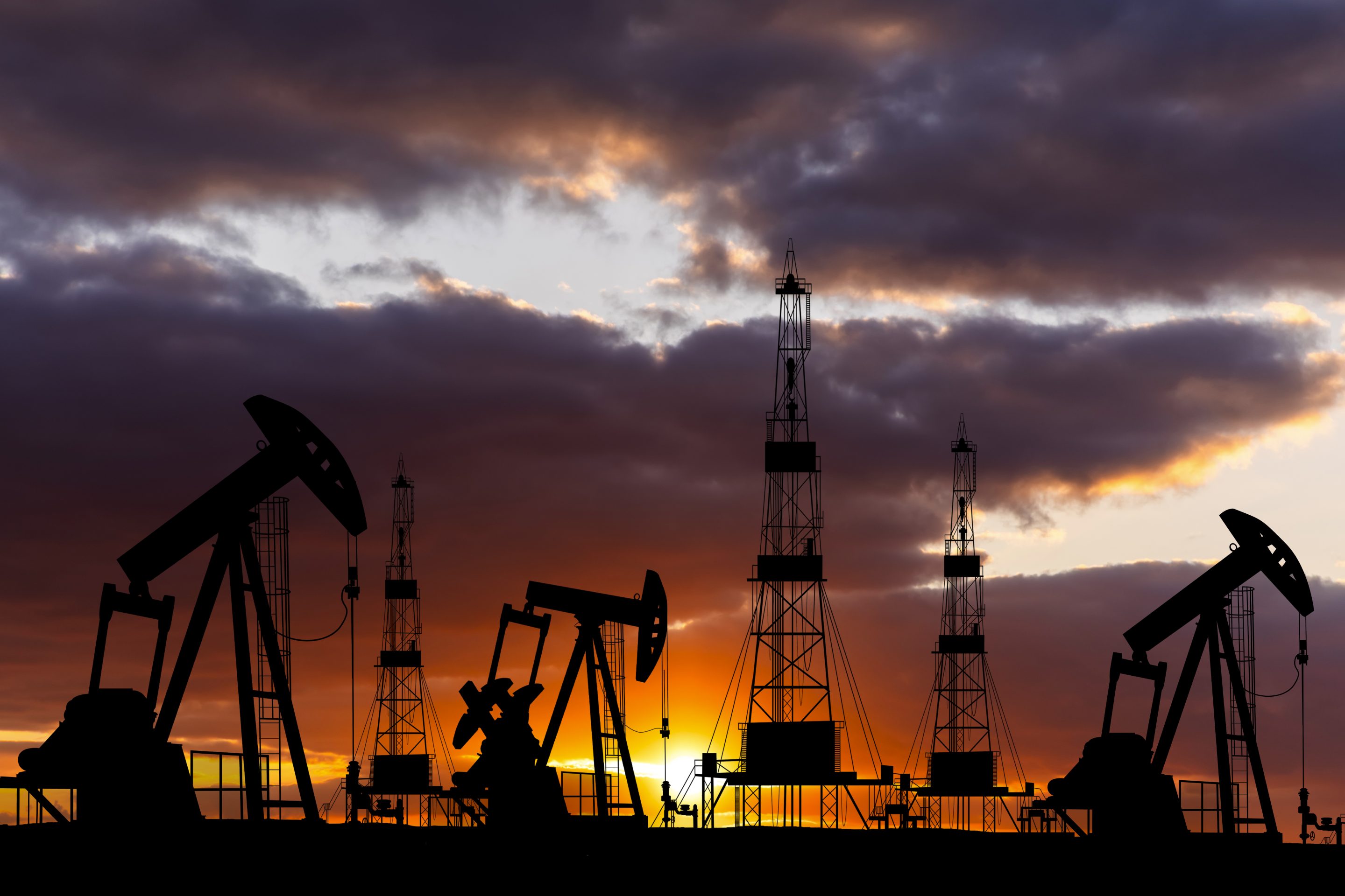 oil rigs at sunset