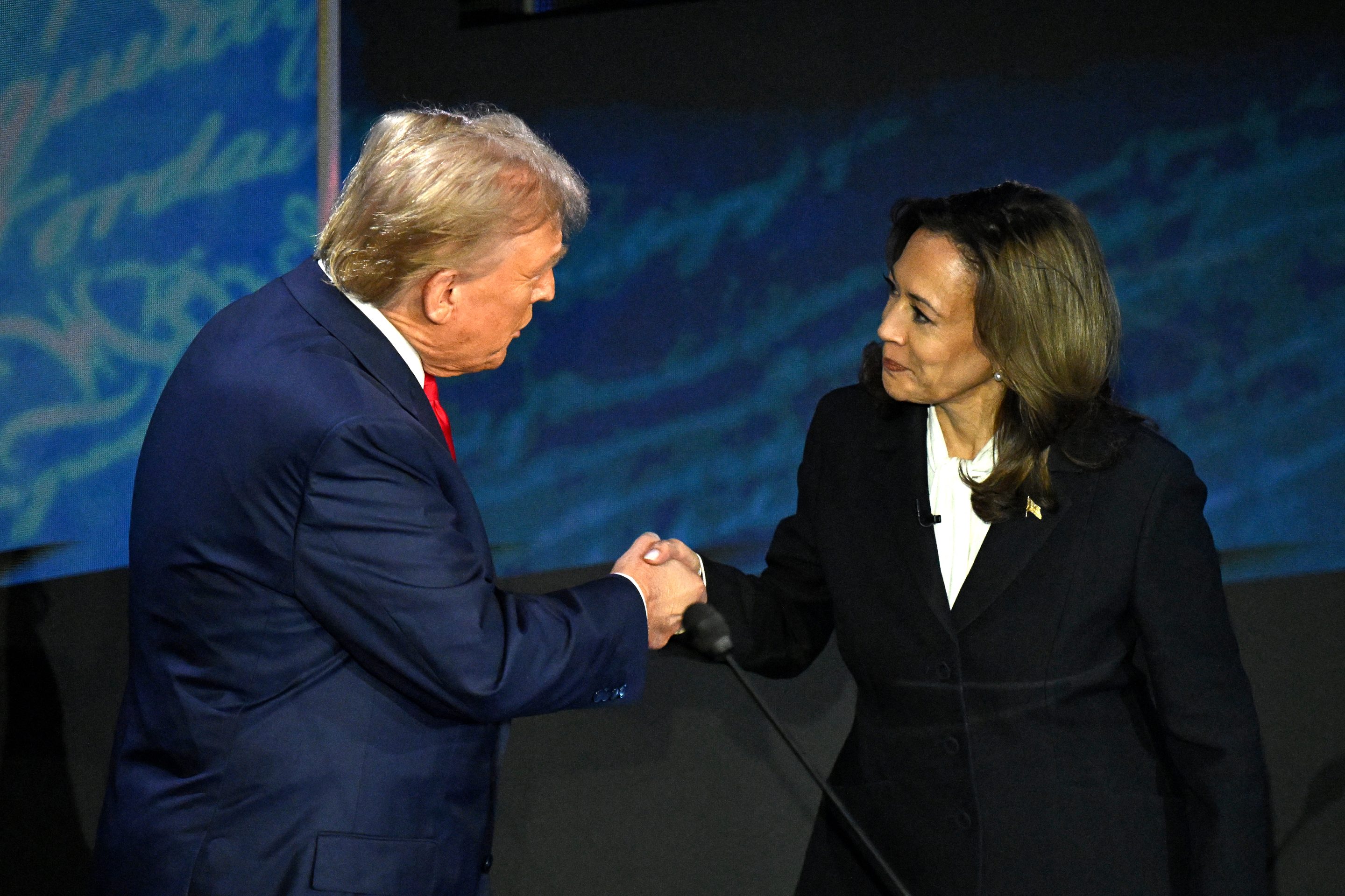 US Vice President and Democratic presidential candidate Kamala Harris (R) shakes hands with former US President and Republican presidential candidate Donald Trump at the debate.