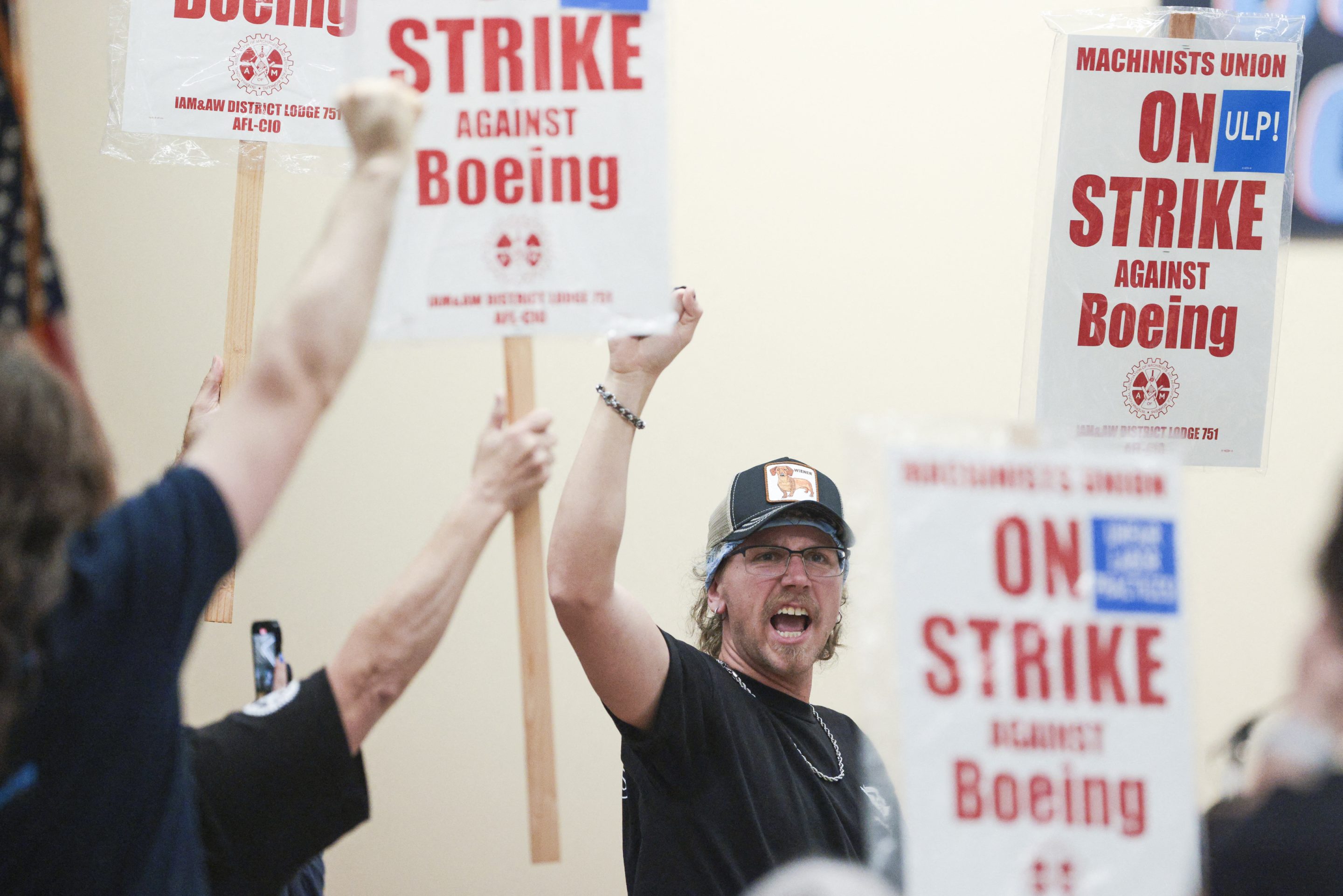 Union members react as Aerospace Machinists District 751 President Jon Holden (out of frame) announces that union members rejected a proposed Boeing contract and will go on strike, following voting results at their union hall in Seattle, Washington, on September 12, 2024.